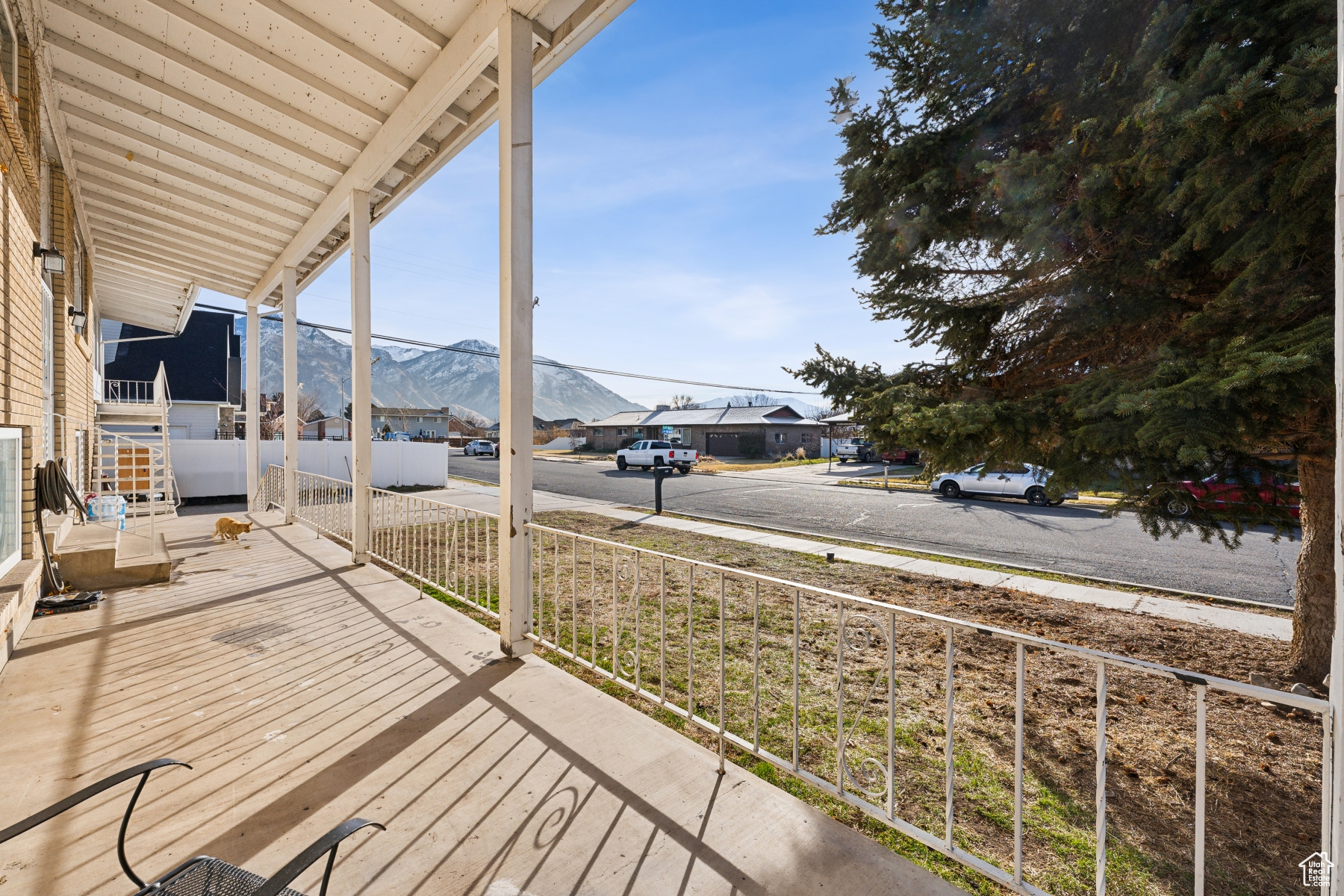 Wooden terrace featuring a mountain view and a porch