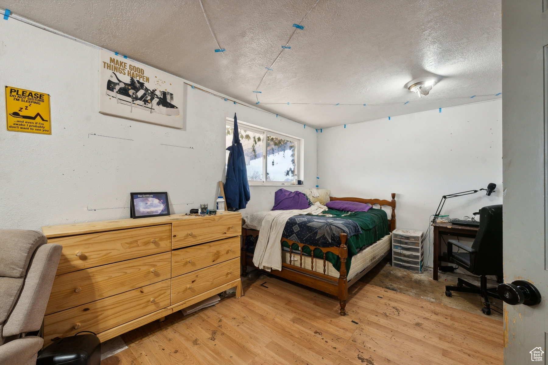 Bedroom featuring wood-type flooring and a textured ceiling