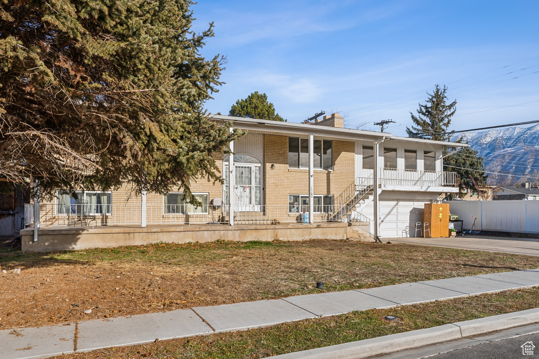 View of front of property featuring covered porch and a garage