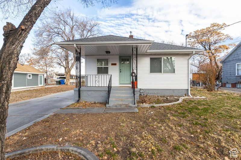 Bungalow-style home with a porch and a front yard