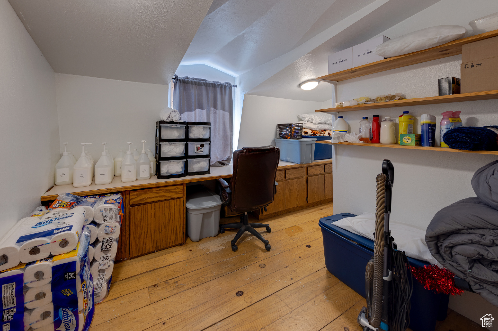 Office space featuring light hardwood / wood-style floors and vaulted ceiling