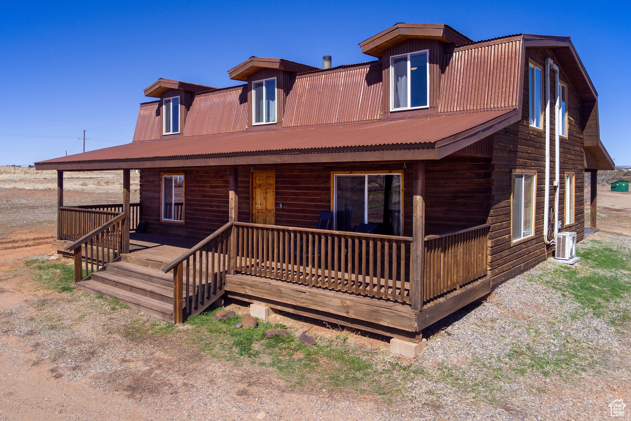 View of front of property featuring covered porch and central AC unit