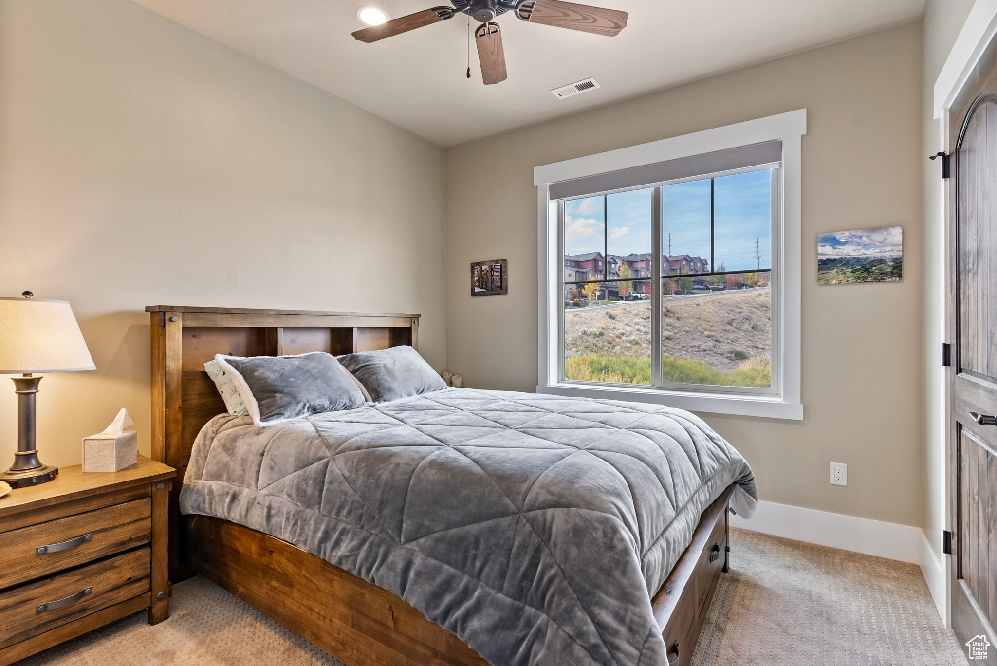 Carpeted bedroom with ceiling fan