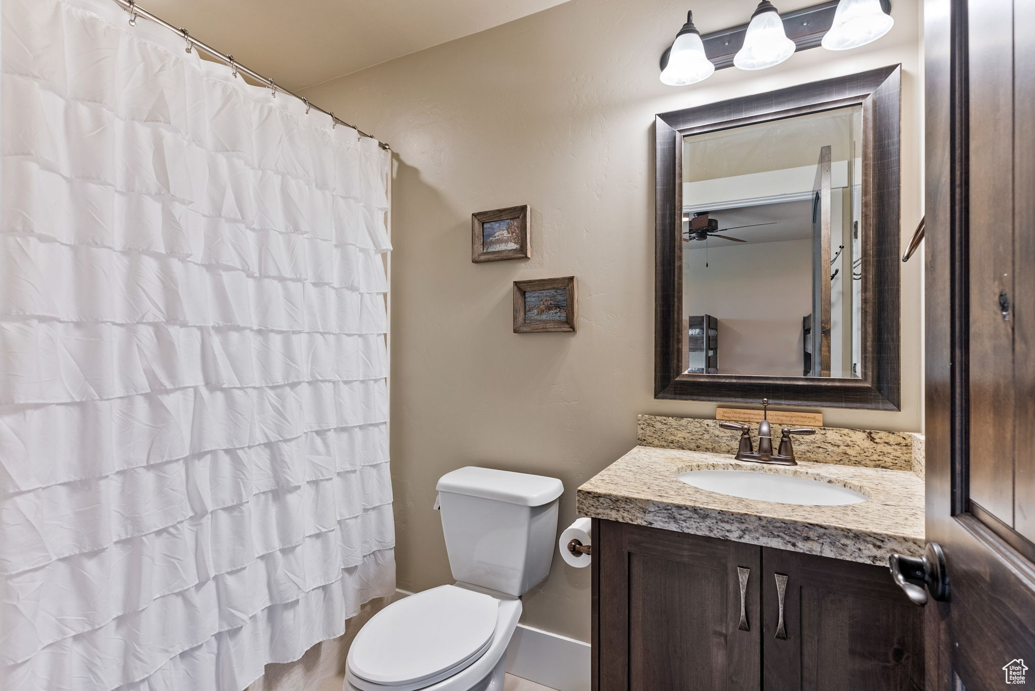 Bathroom with vanity, ceiling fan, and toilet