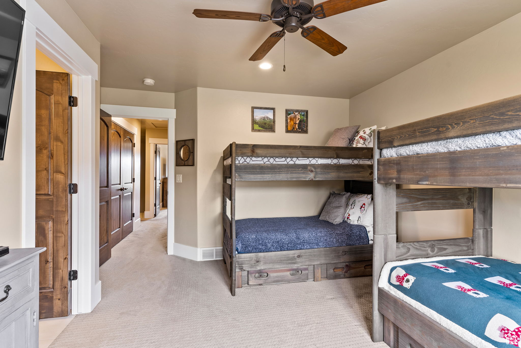 Bedroom with ceiling fan and light carpet