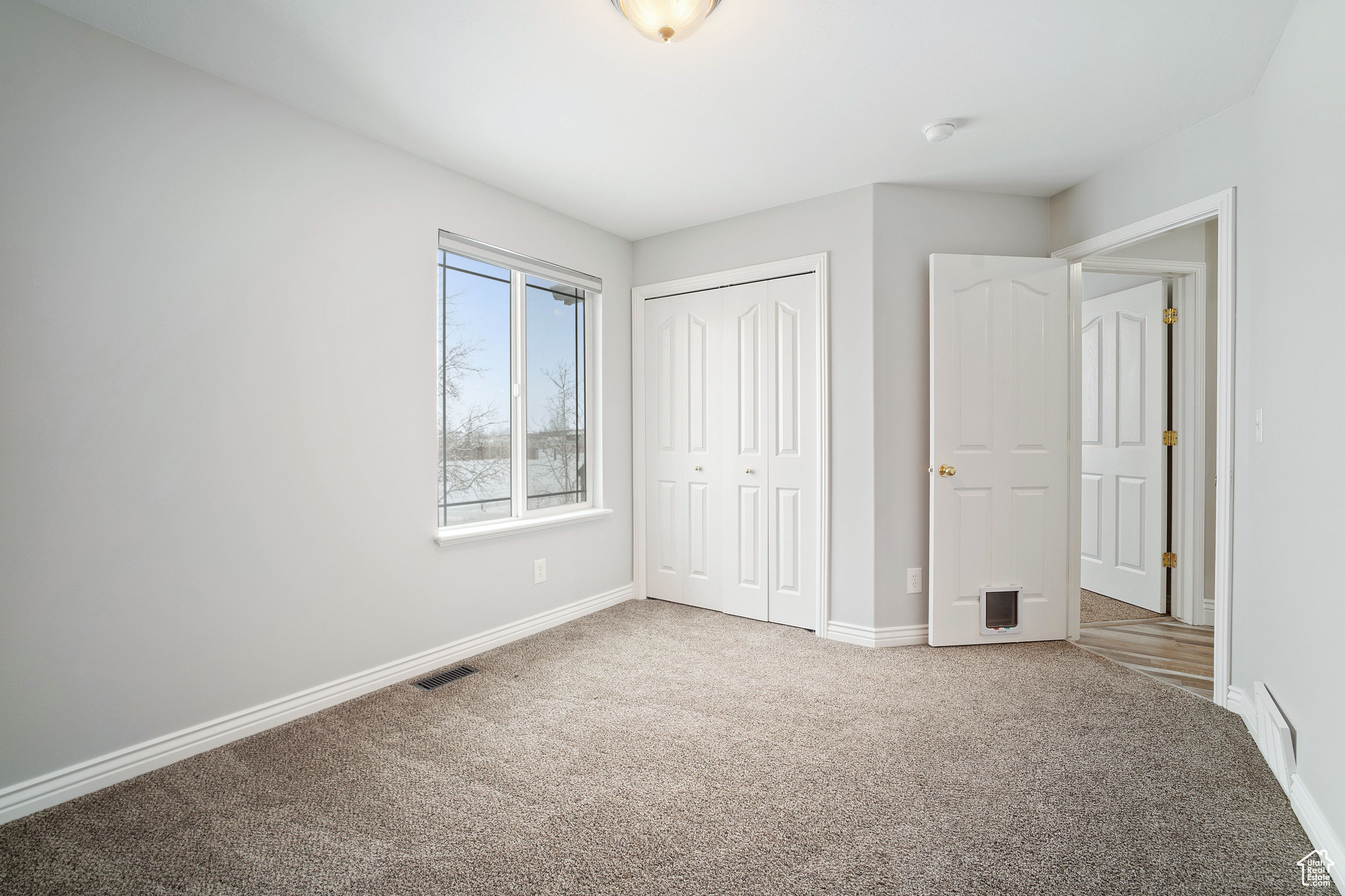 Unfurnished bedroom with a closet and carpet