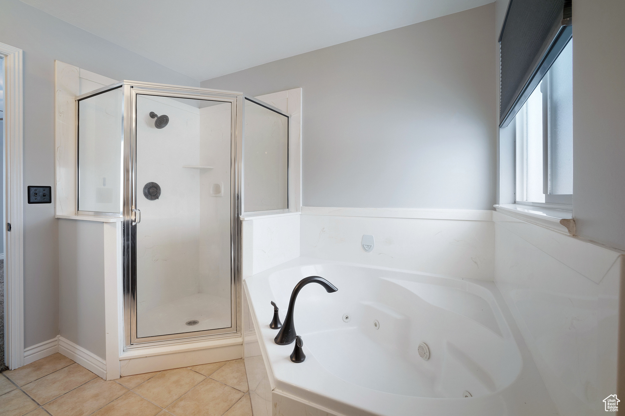 Bathroom featuring tile patterned floors and separate shower and tub