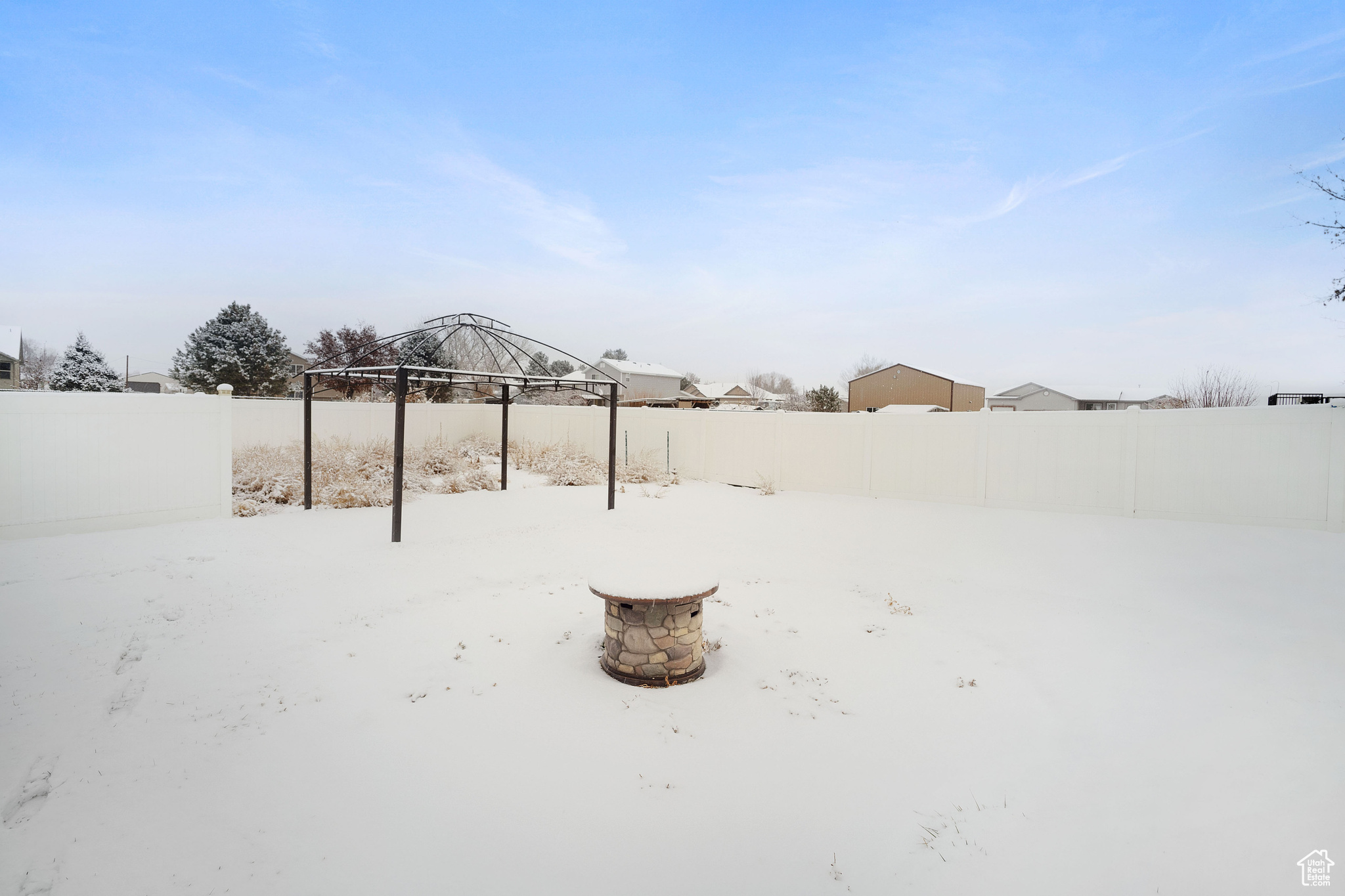 Snowy yard with a fire pit