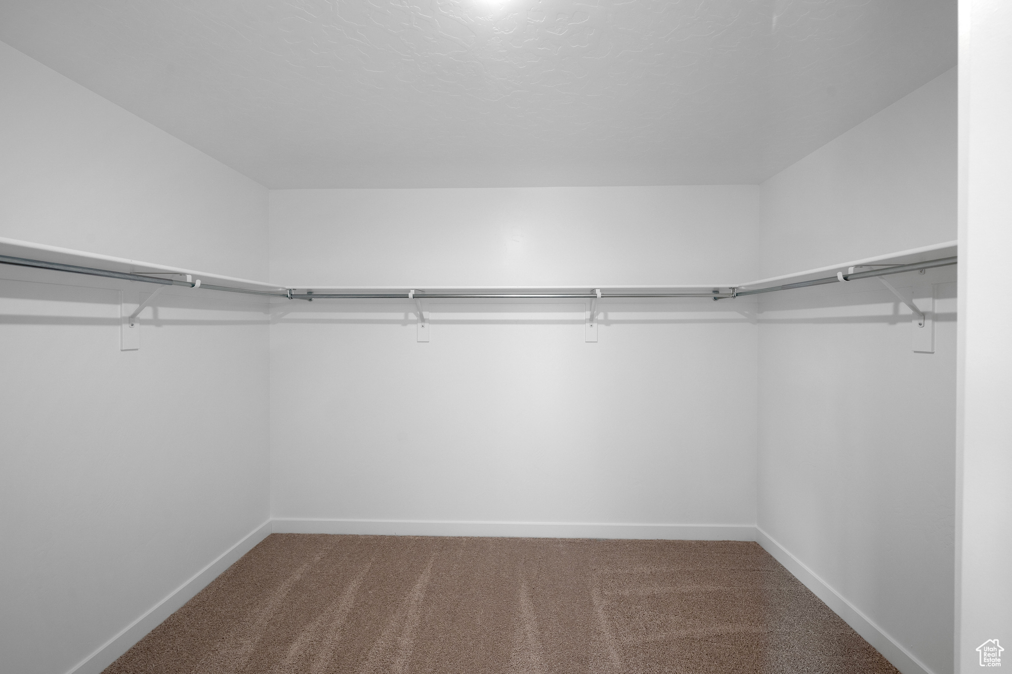 Walk in closet in primary bedroom