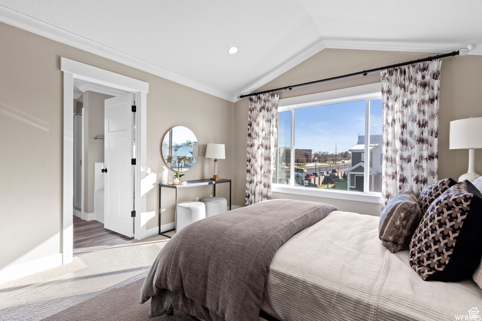 Bedroom featuring lofted ceiling and ornamental molding