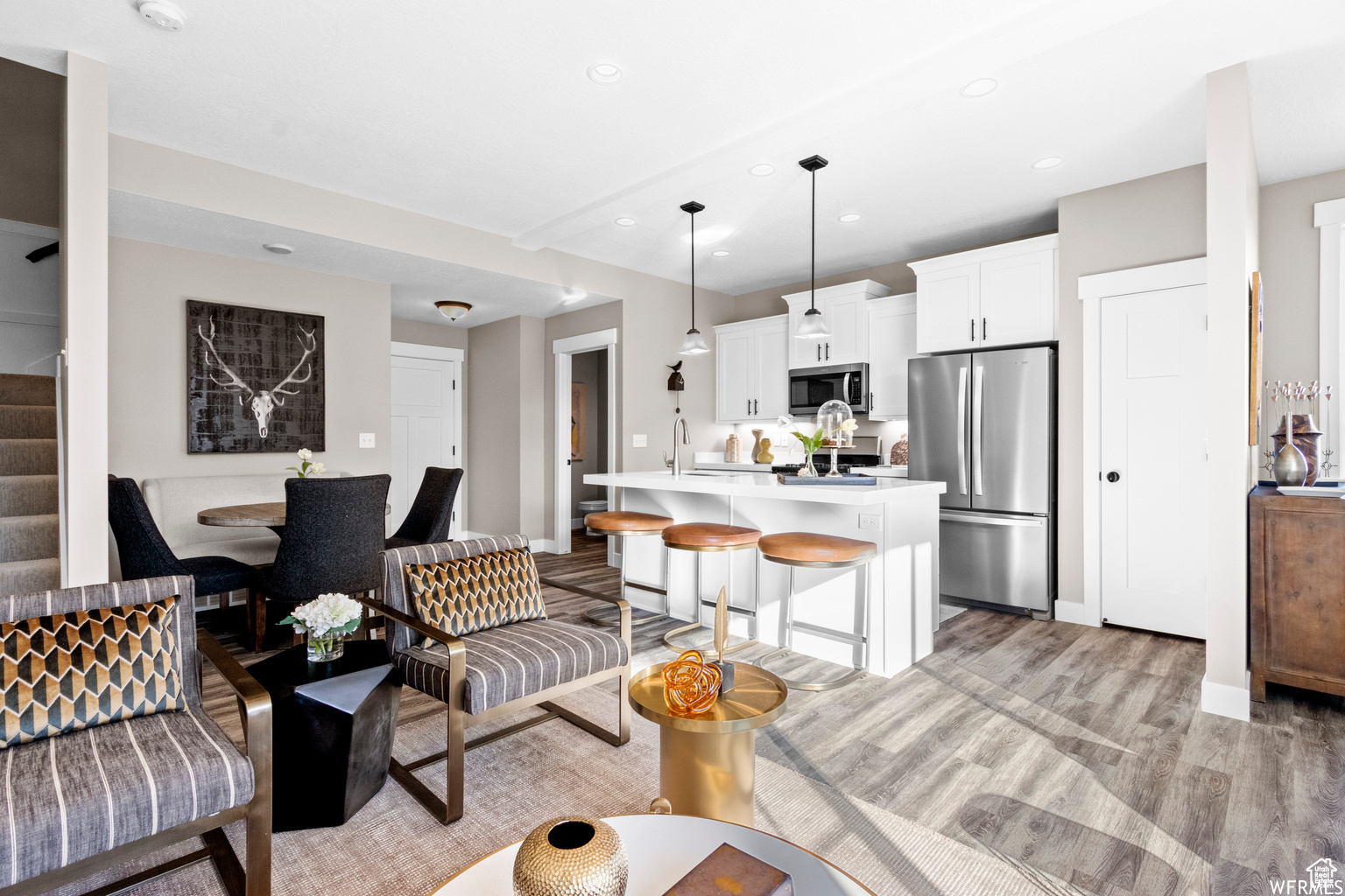 Living room featuring light wood-type flooring and sink