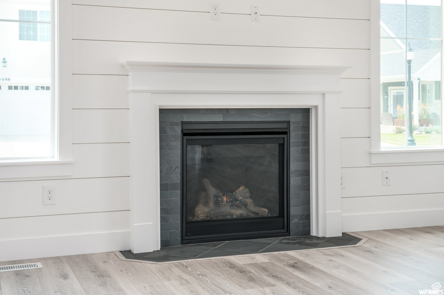 Interior details featuring hardwood / wood-style floors and wood walls