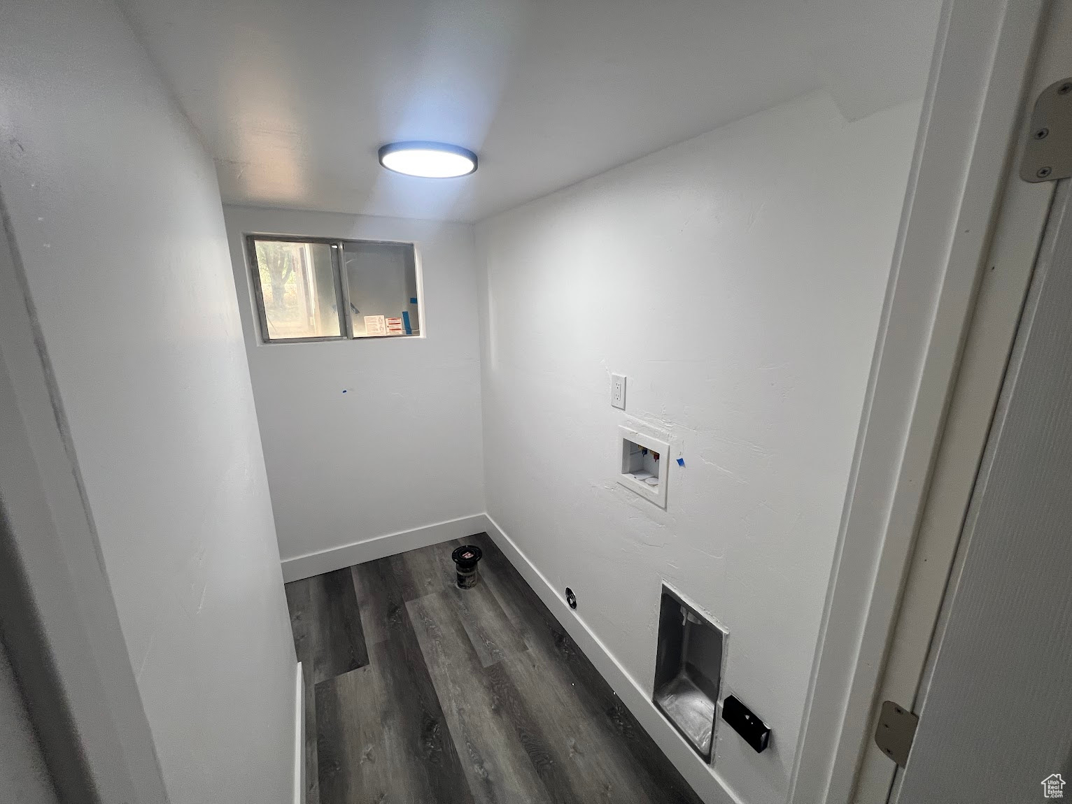 Laundry room featuring dark hardwood / wood-style flooring and washer hookup