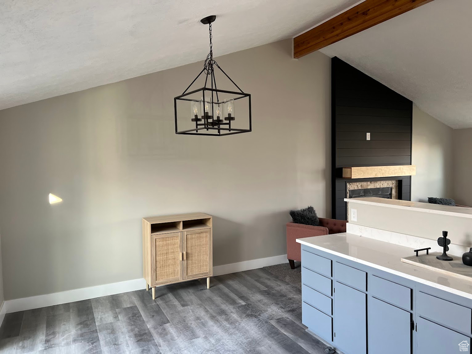 Interior space featuring a chandelier, pendant lighting, lofted ceiling with beams, and dark hardwood / wood-style flooring