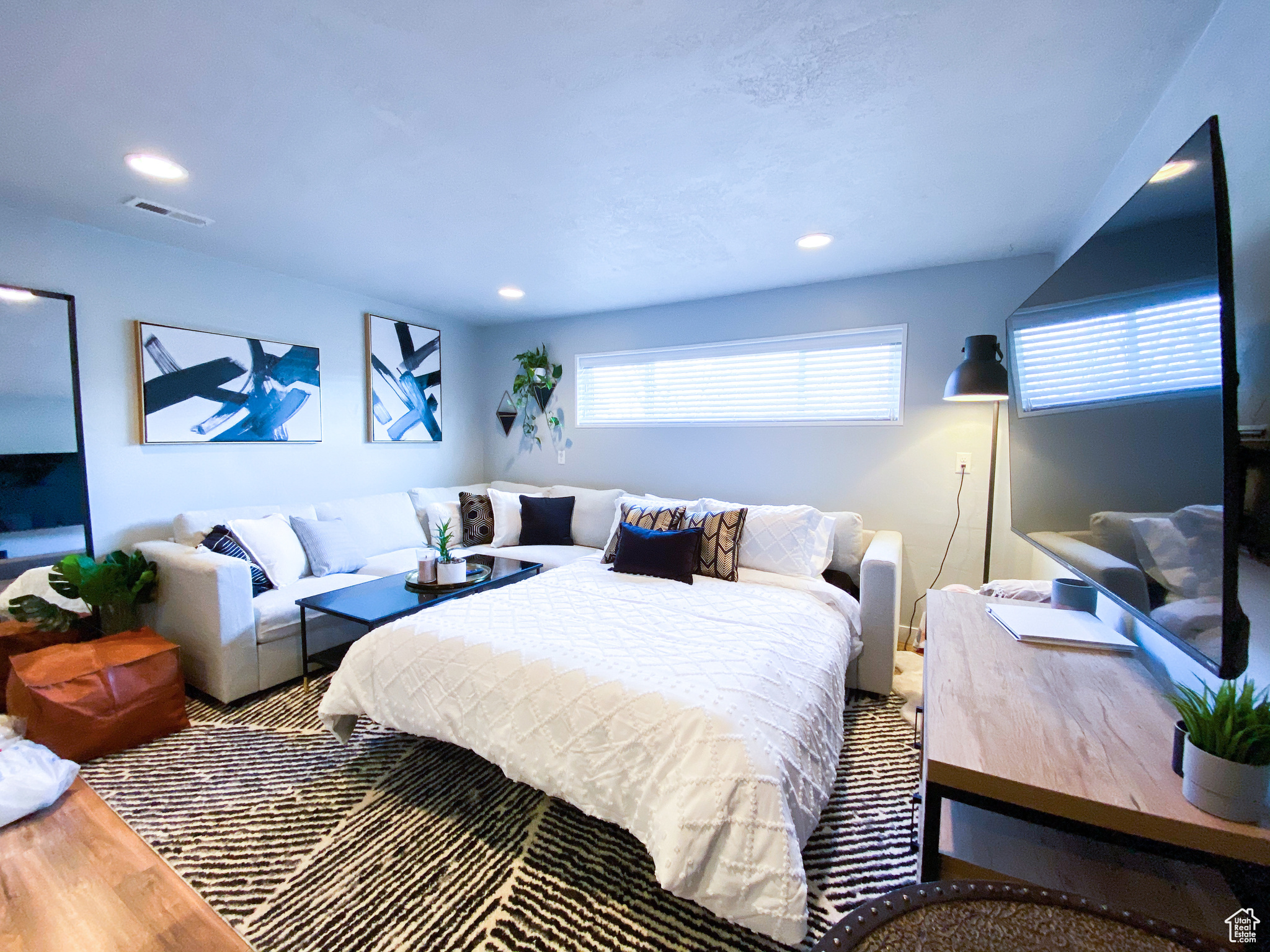 Downstairs Living Room with extended Queen Sized Hide-a-bed with hardwood / wood-style floors