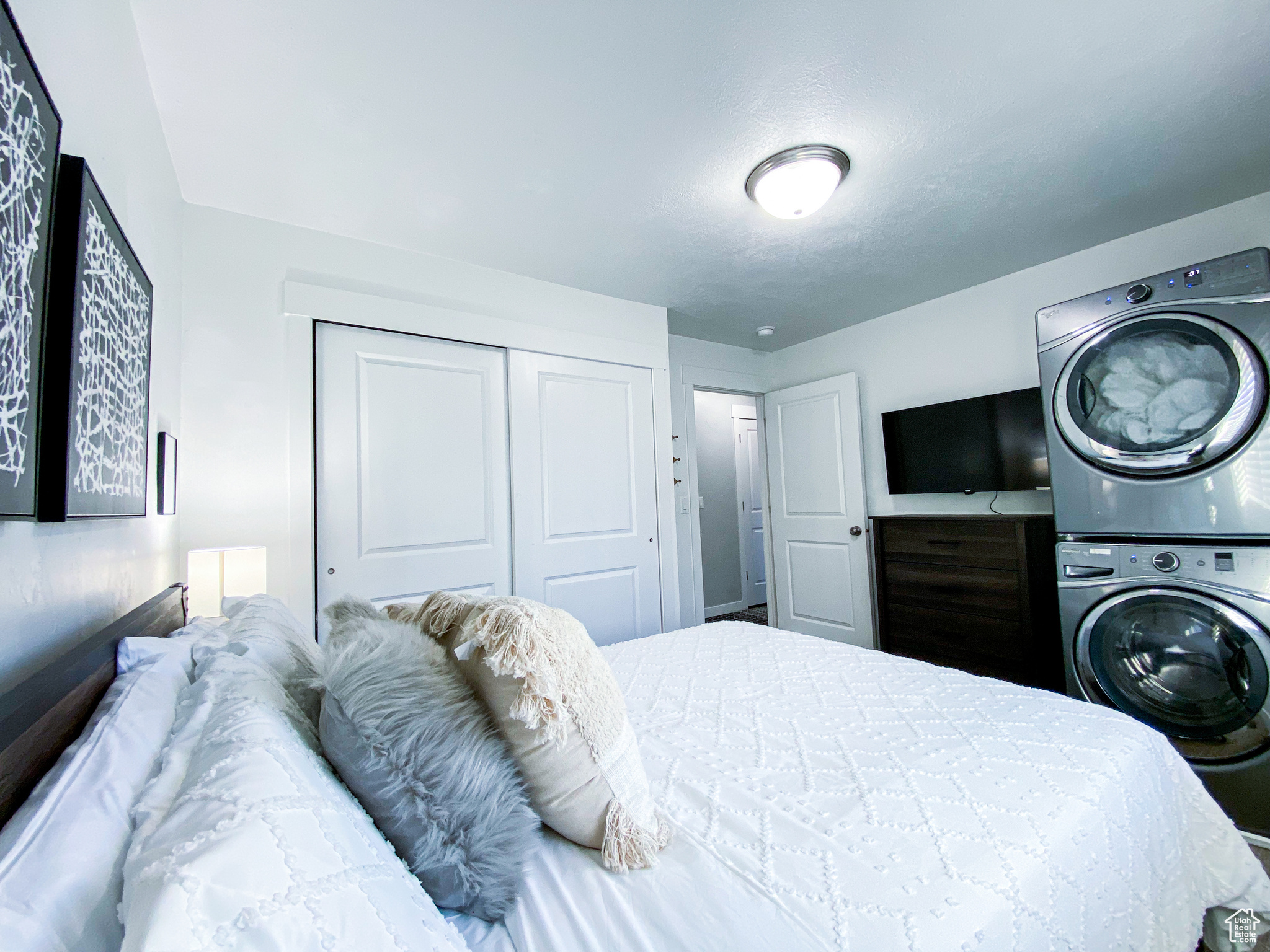 Upstairs Queen Bedroom with a closet and stacked washer / drying machine