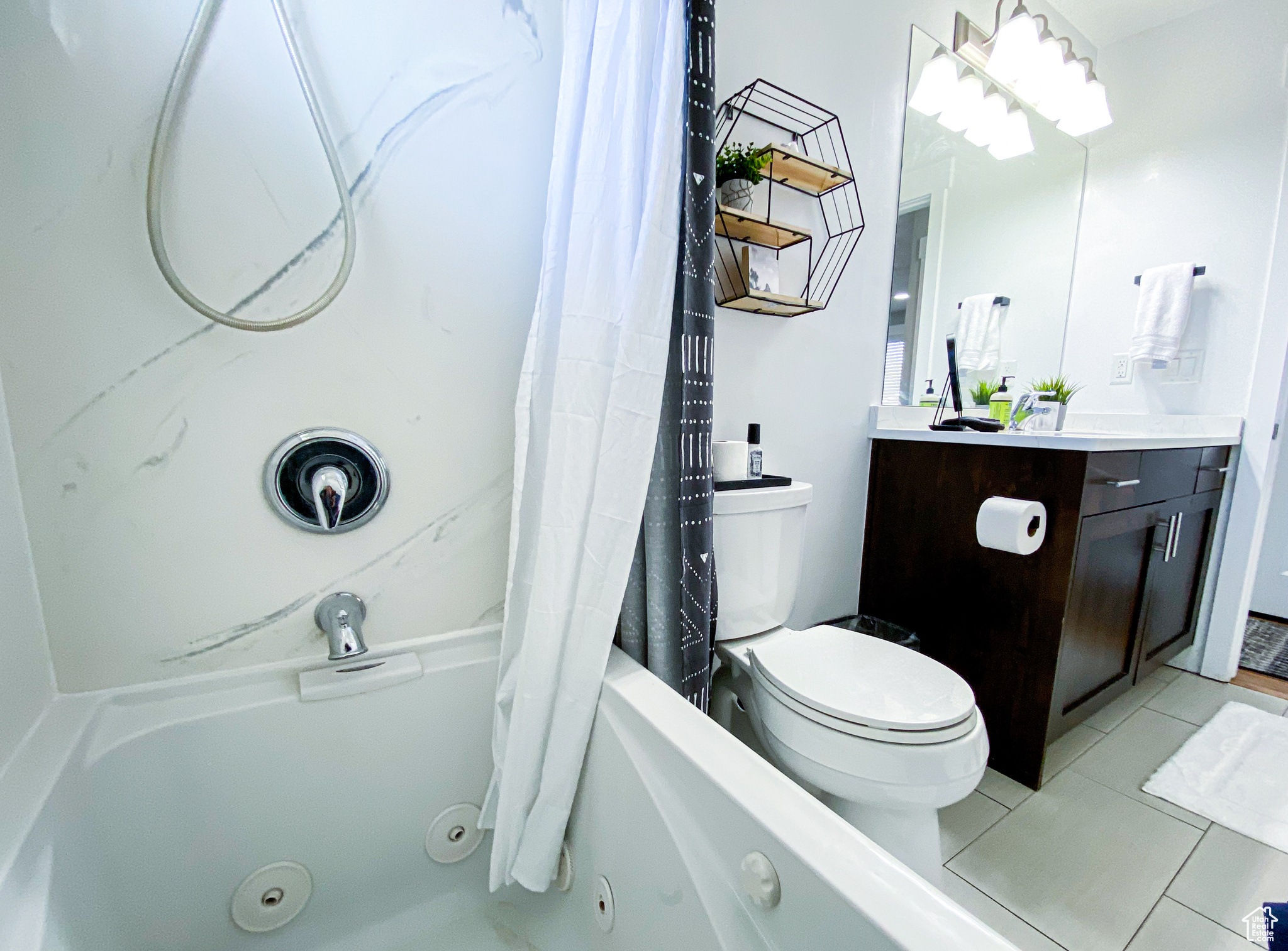 Upstairs Full bathroom featuring tile patterned flooring, vanity, shower / tub combo with curtain, and toilet