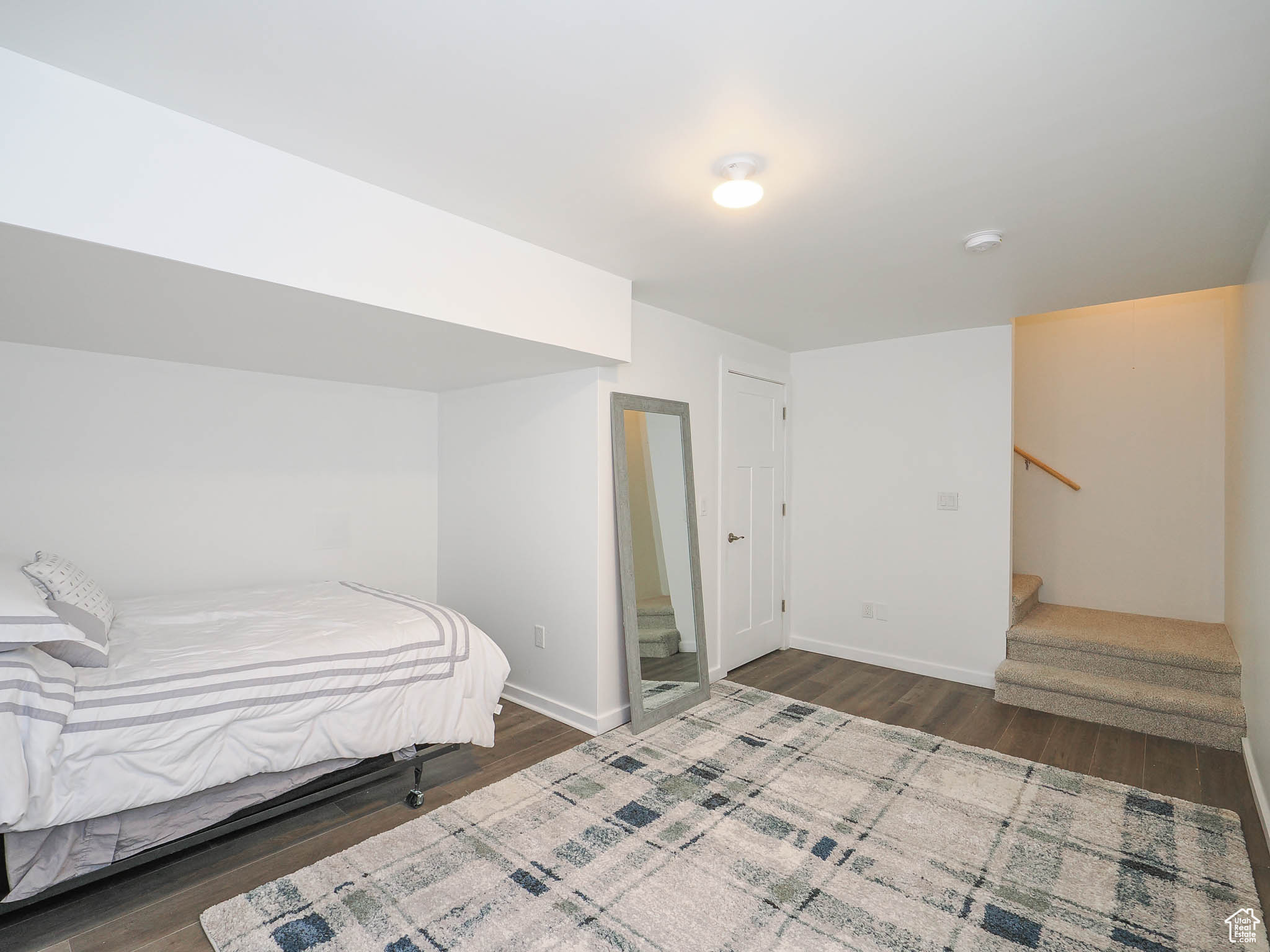 Bedroom with dark wood-type flooring