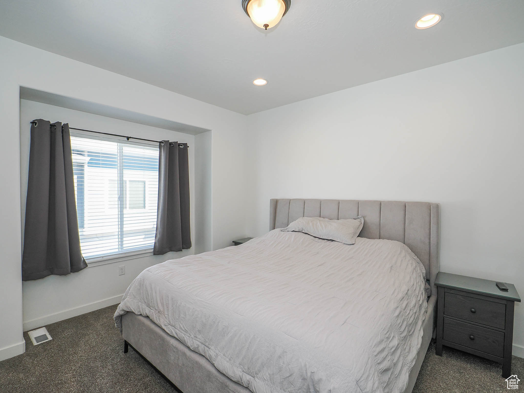 Bedroom featuring dark colored carpet