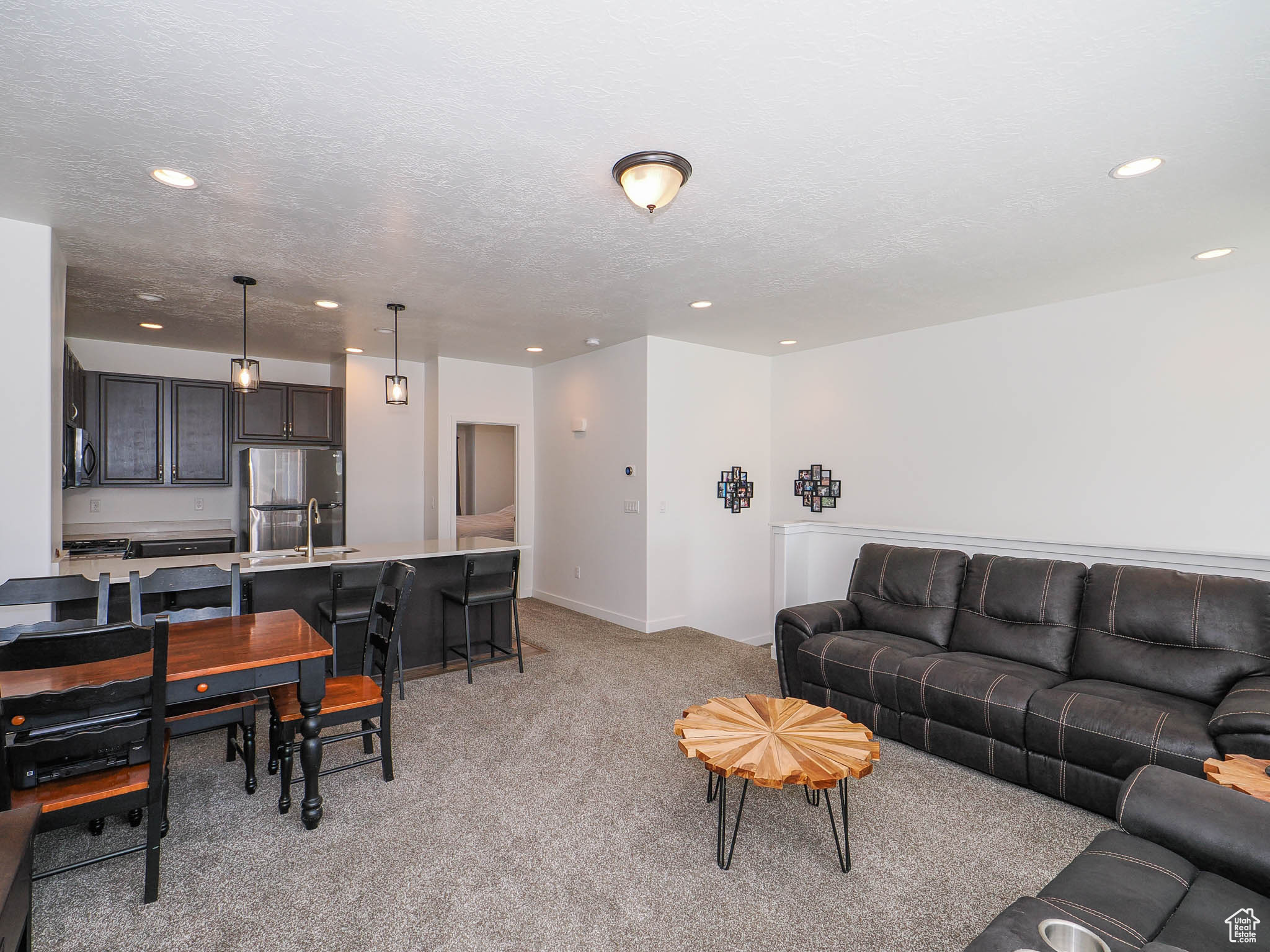 Carpeted living room with a textured ceiling