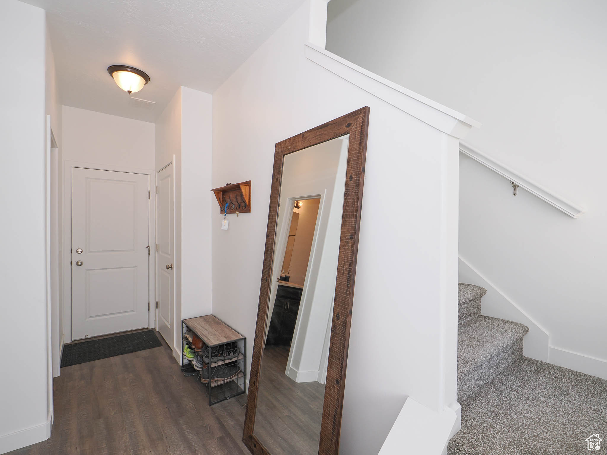 Hall featuring dark wood-type flooring