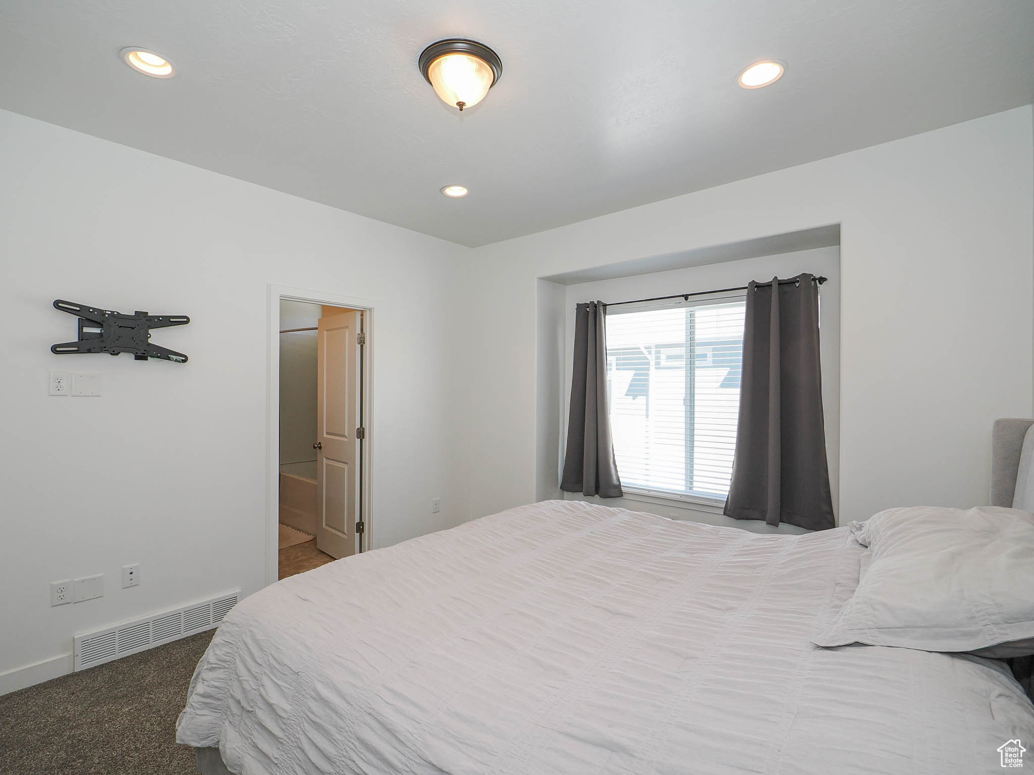 Carpeted bedroom with ensuite bath