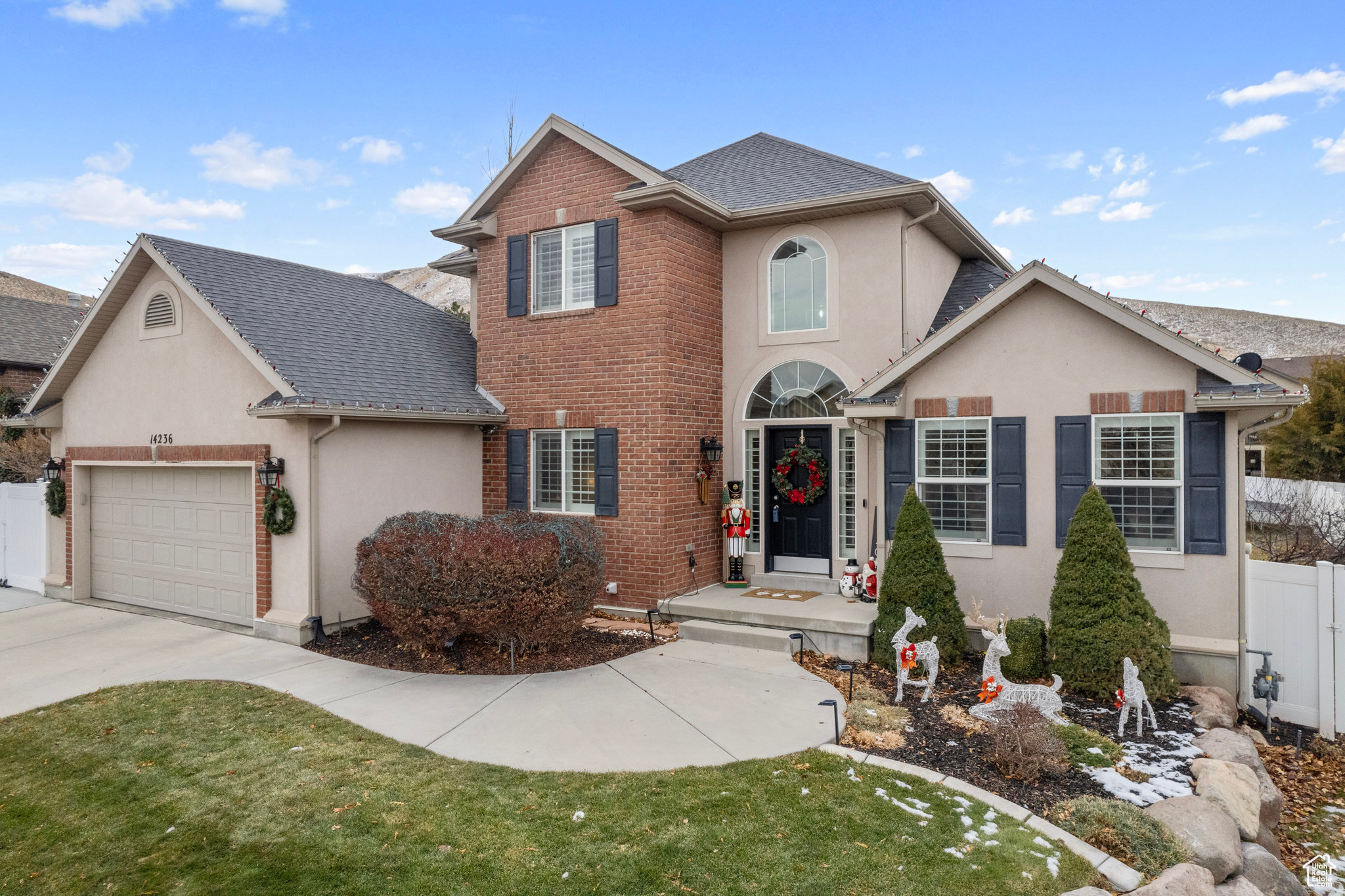 View of property featuring a front lawn and a garage