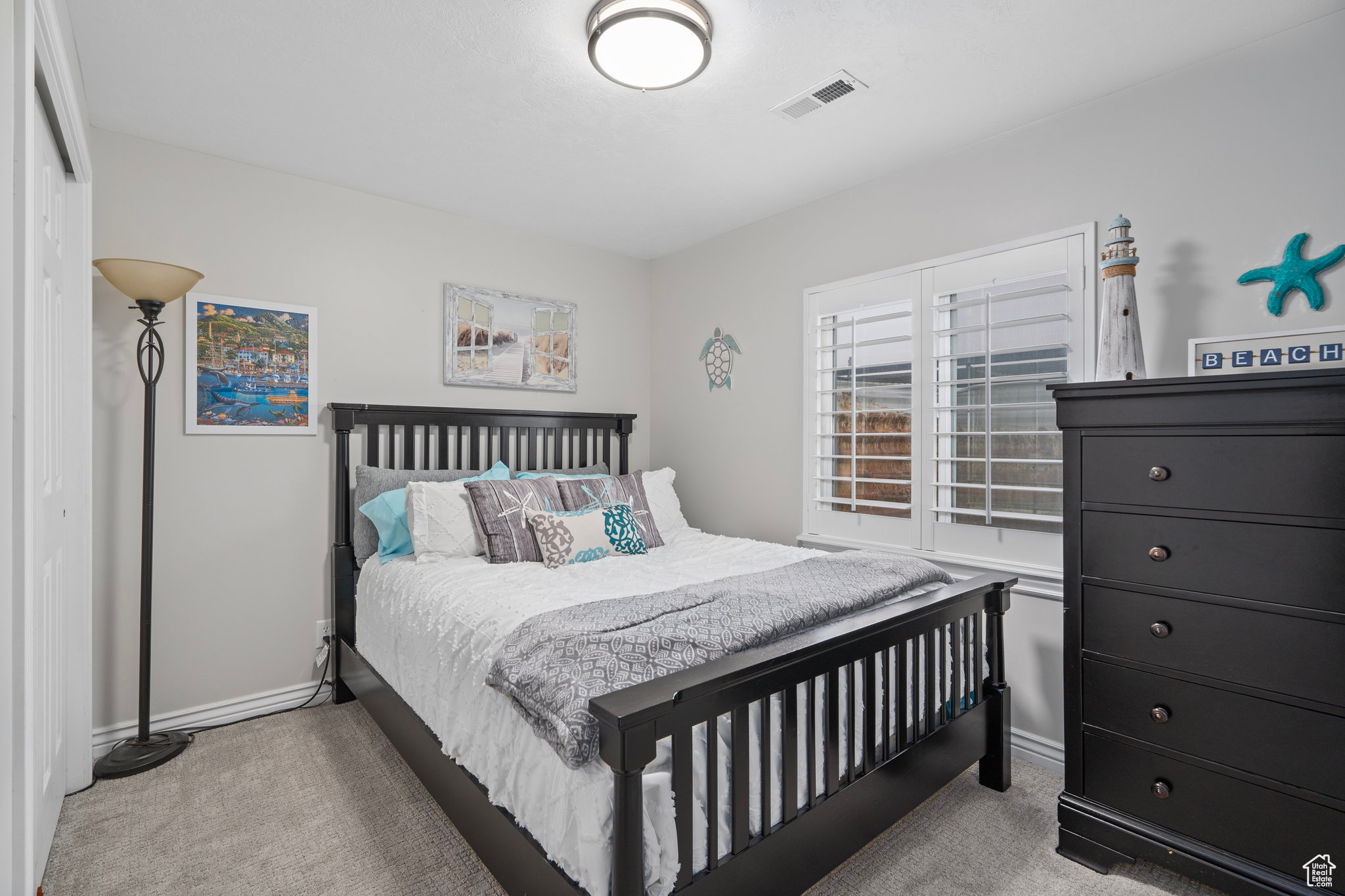 Bedroom featuring light carpet