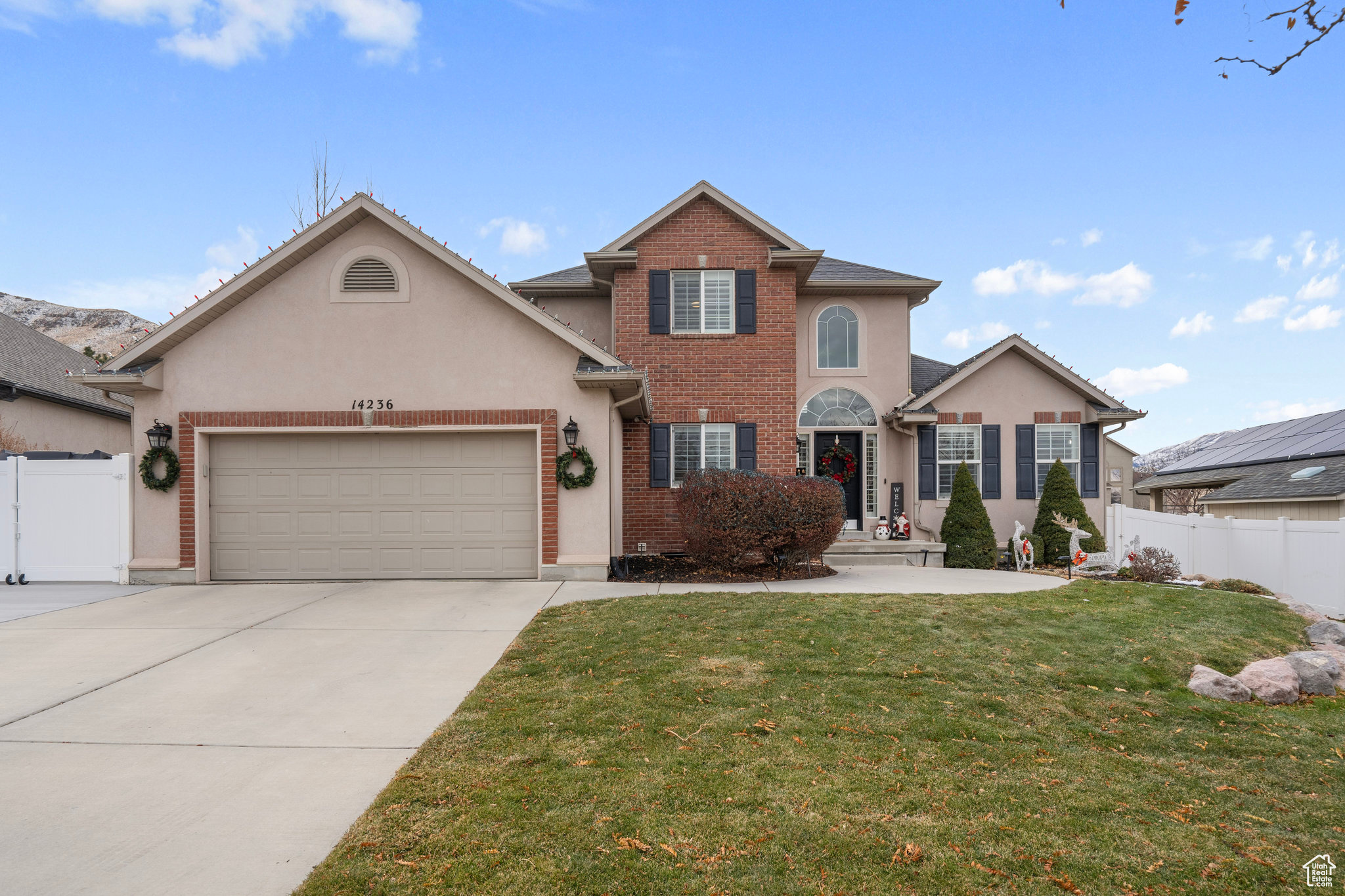 Front of property featuring a garage and a front yard