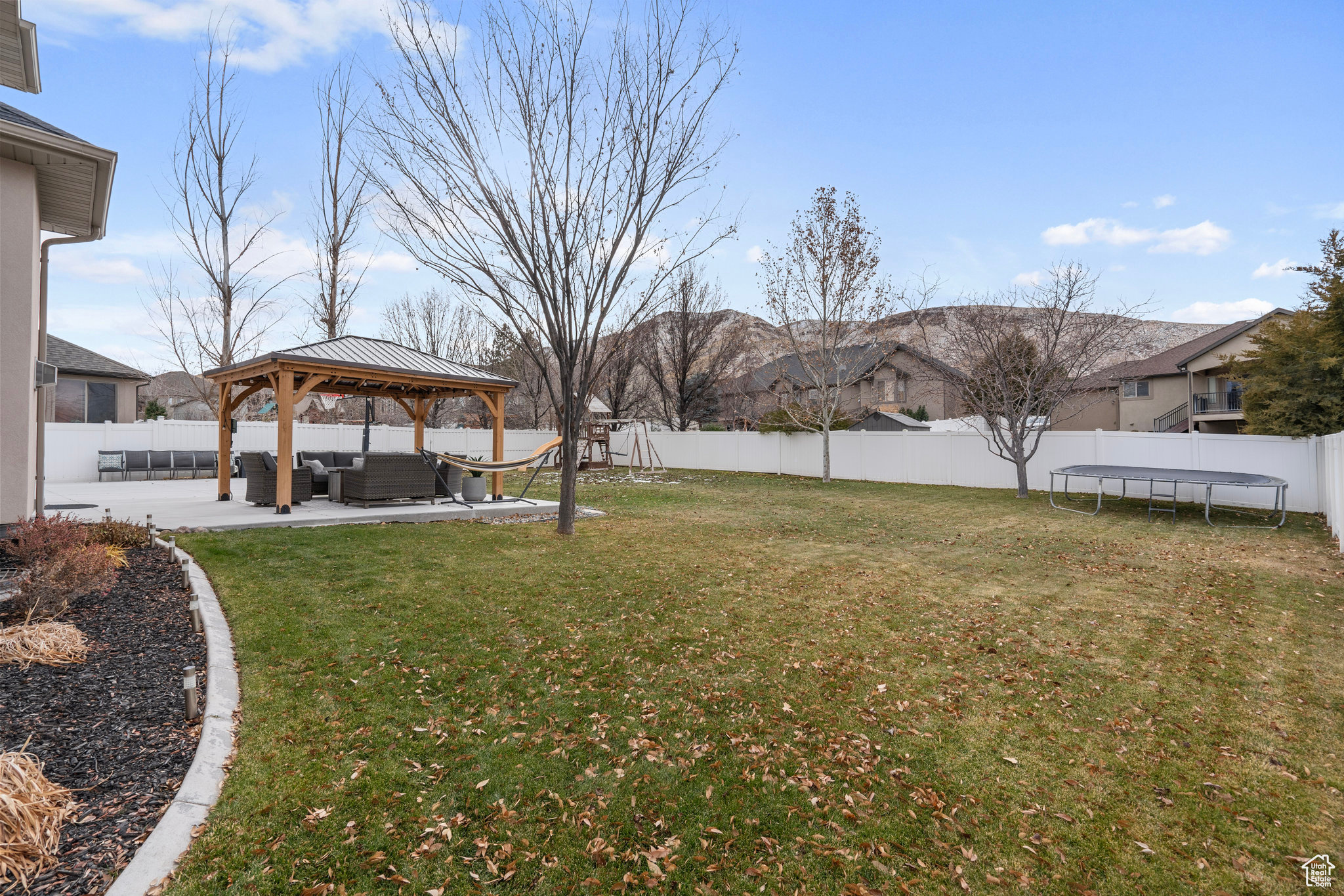 View of yard with a gazebo, an outdoor living space, a trampoline, and a patio area