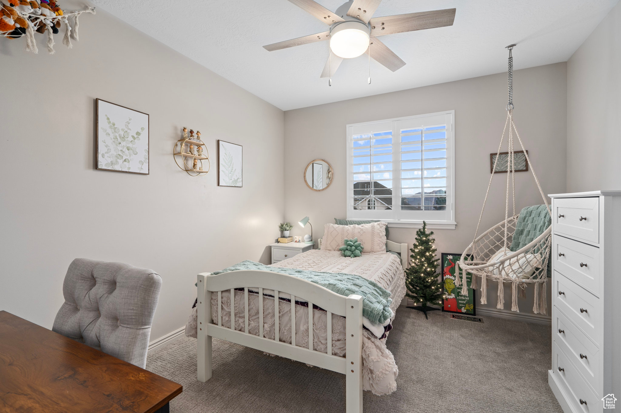 Carpeted bedroom featuring ceiling fan