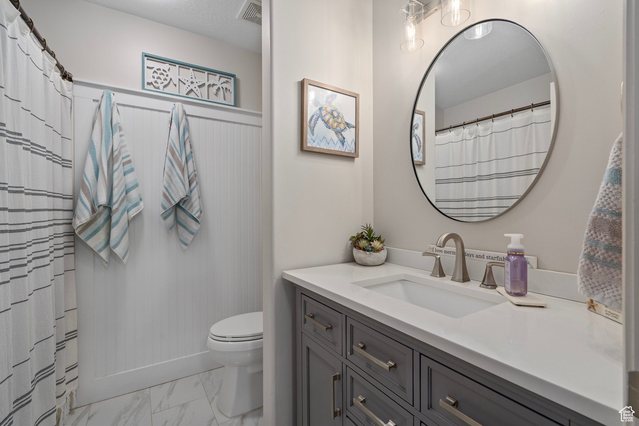 Bathroom featuring vanity and toilet