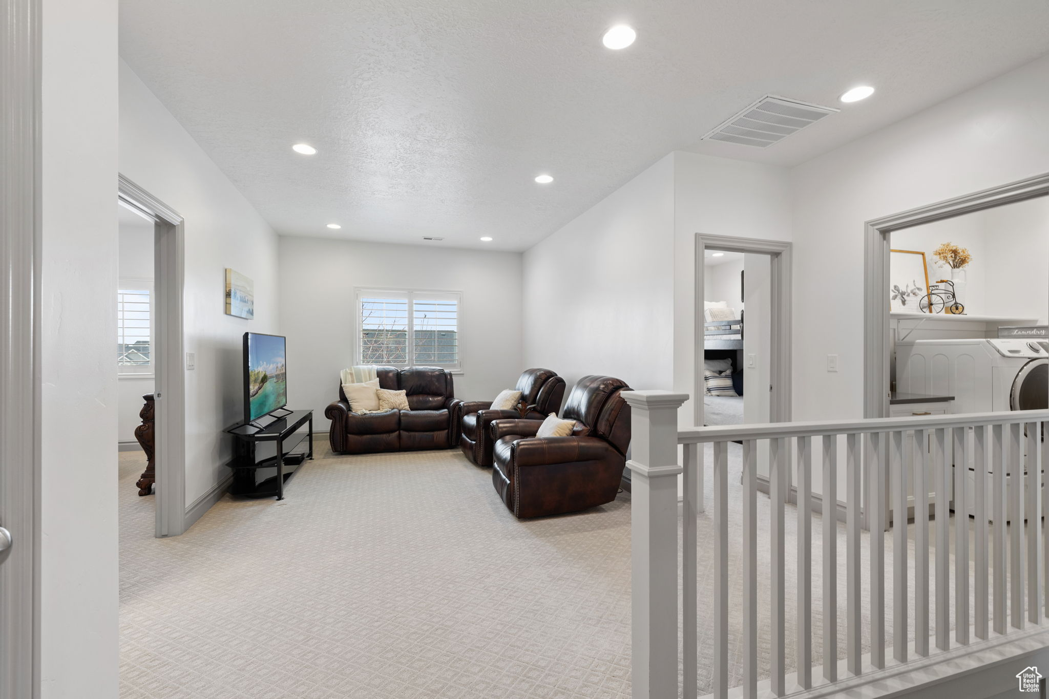 Carpeted living room with washer / clothes dryer