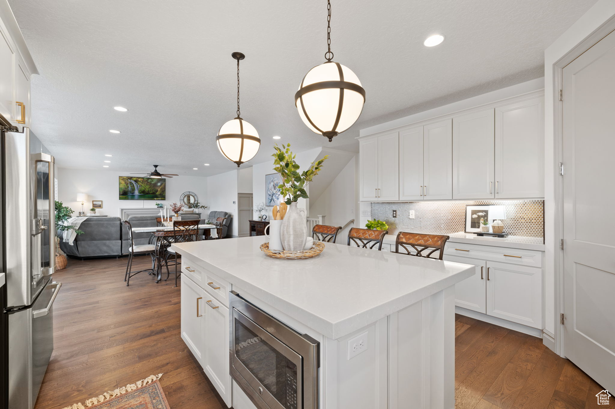 Kitchen featuring a center island, white cabinets, and appliances with stainless steel finishes