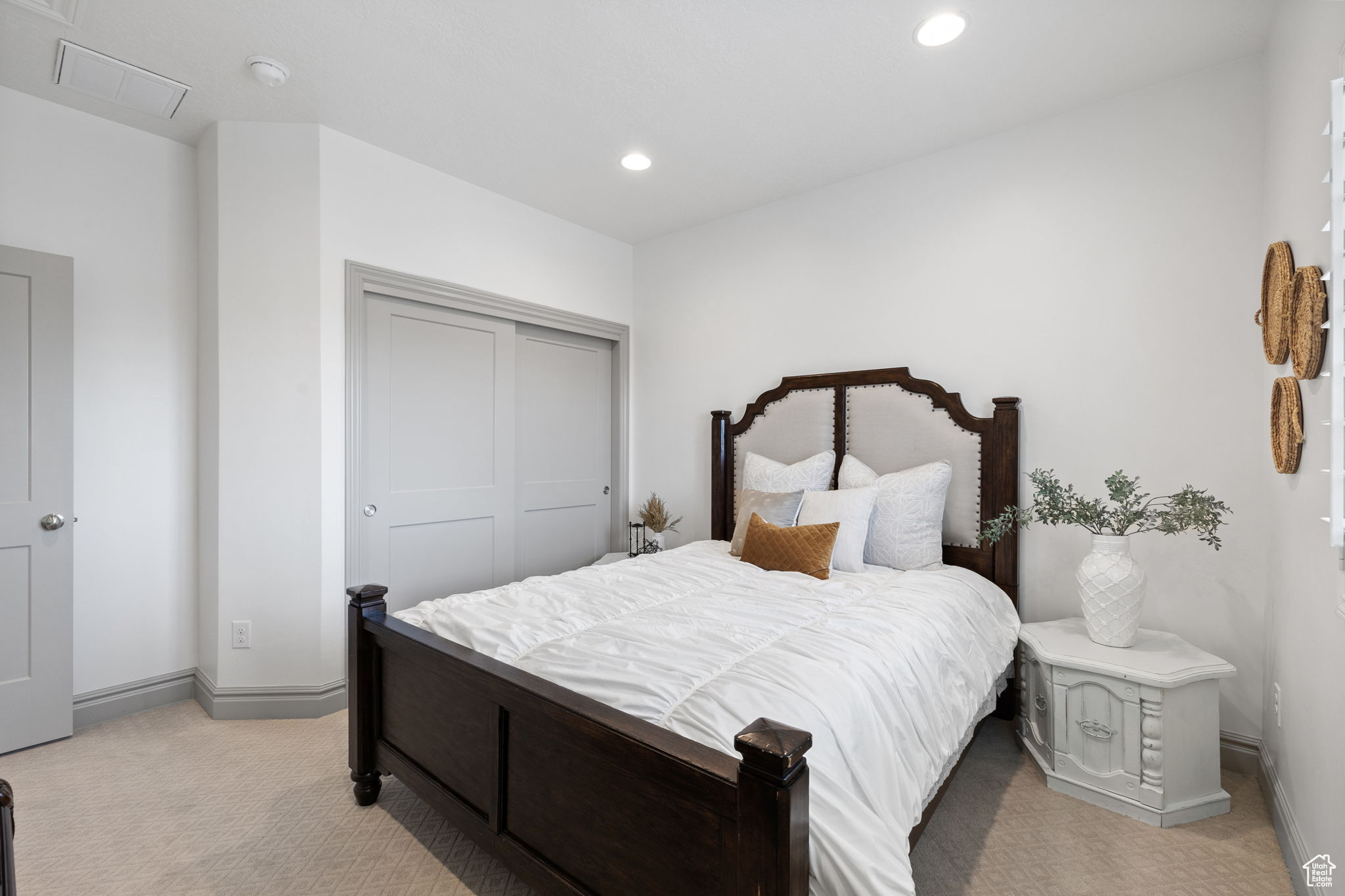 Carpeted bedroom featuring a closet