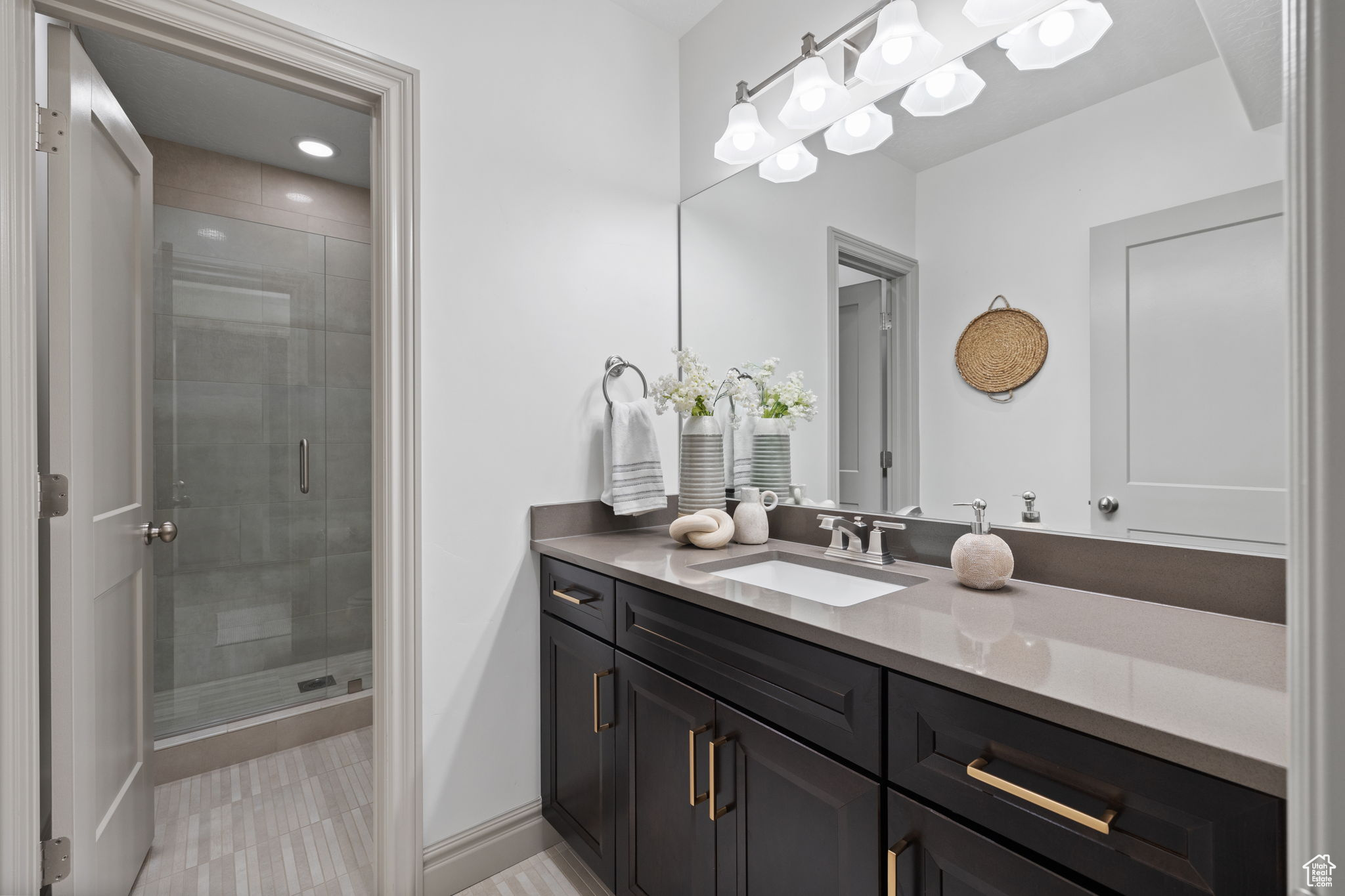 Bathroom featuring vanity and an enclosed shower