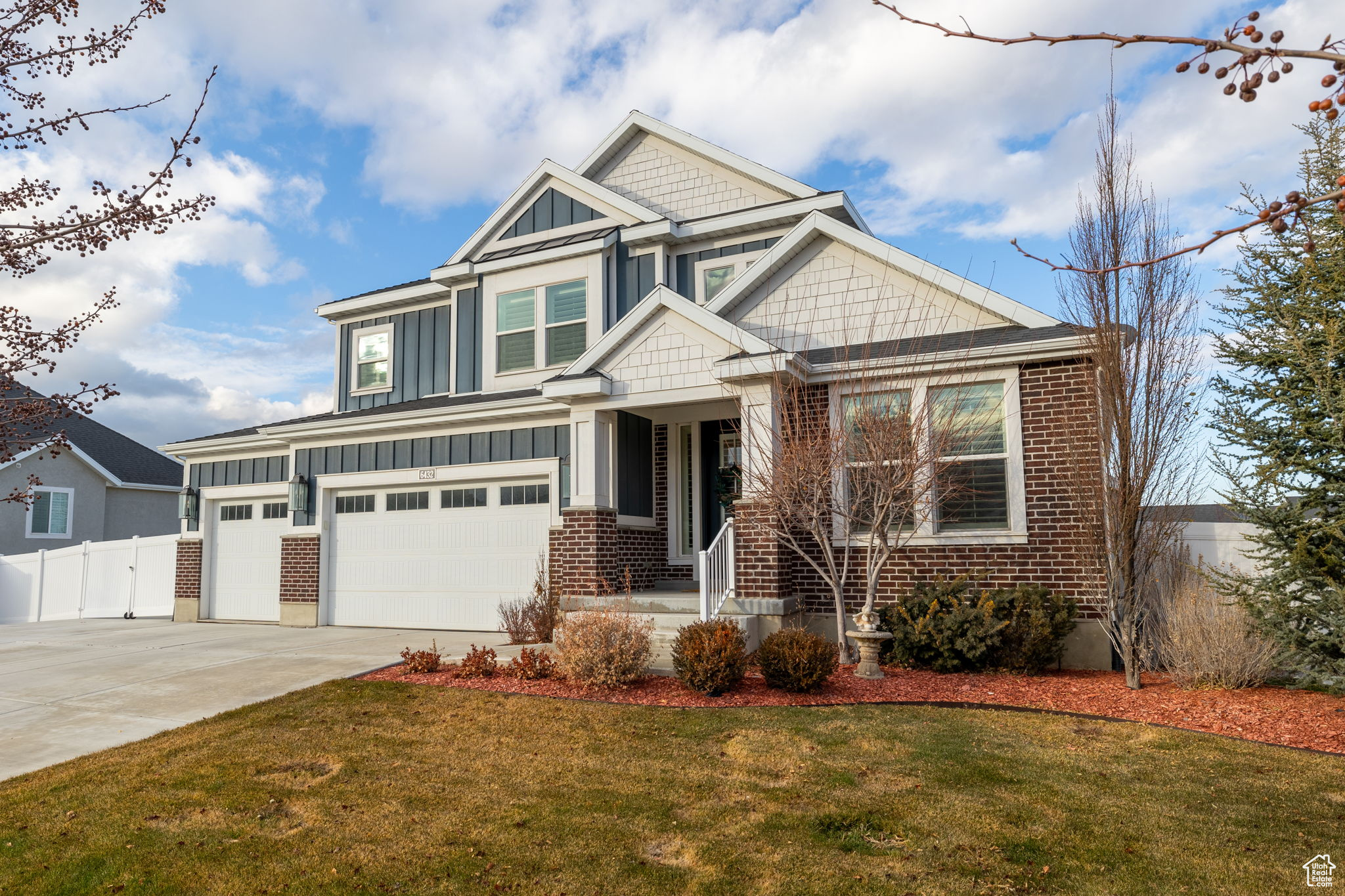 Craftsman-style home with a front yard and a garage