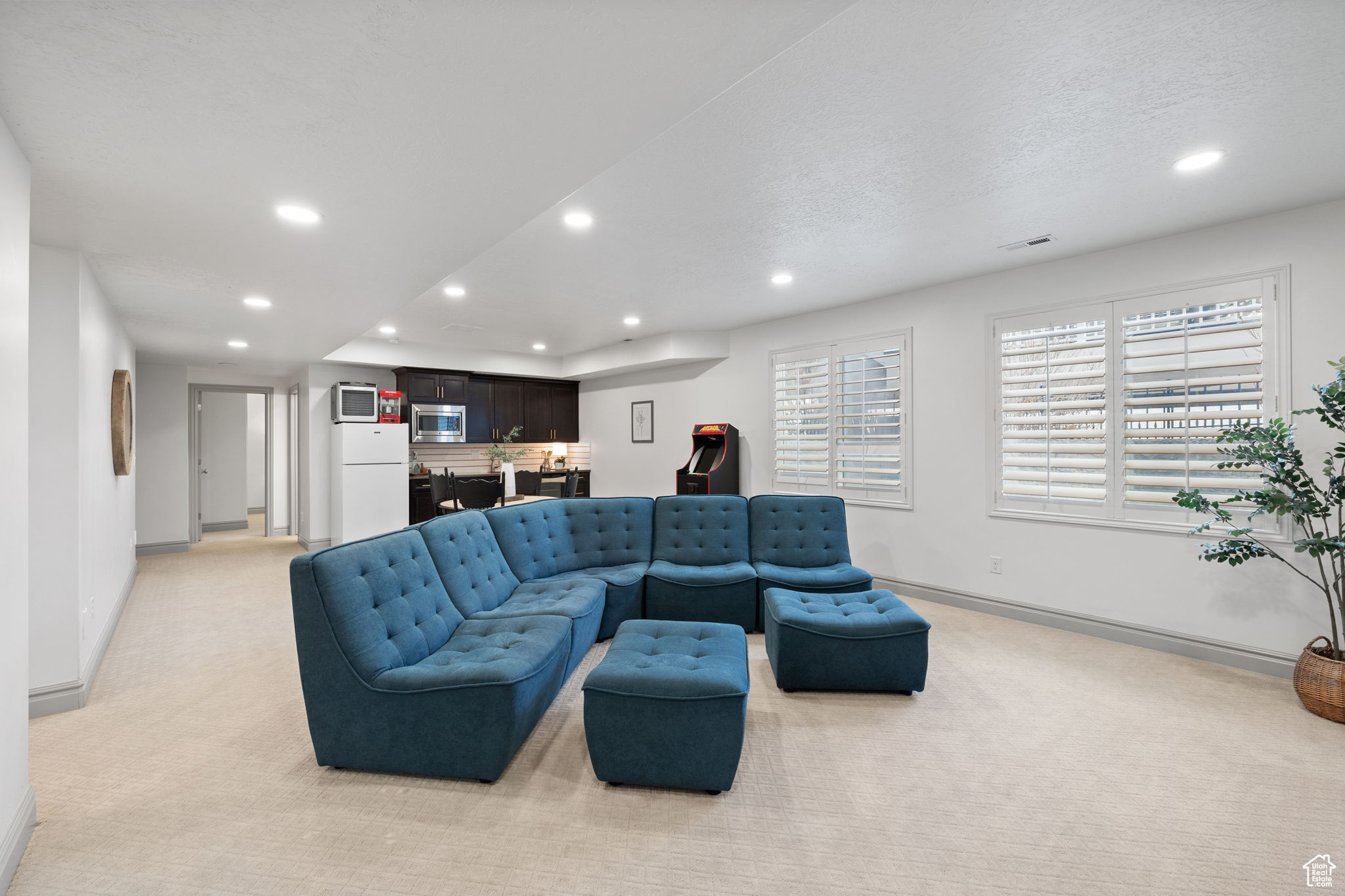 Carpeted living room with a textured ceiling