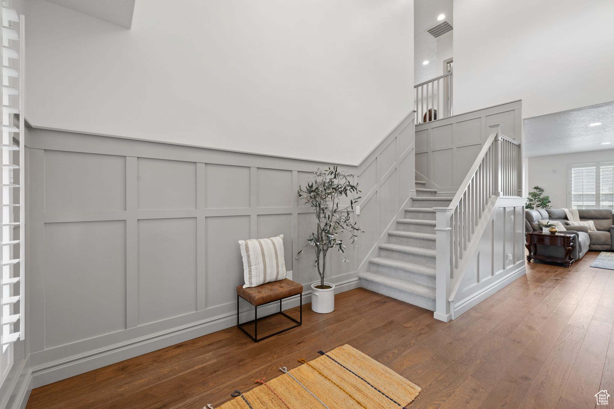 Stairs featuring hardwood / wood-style floors