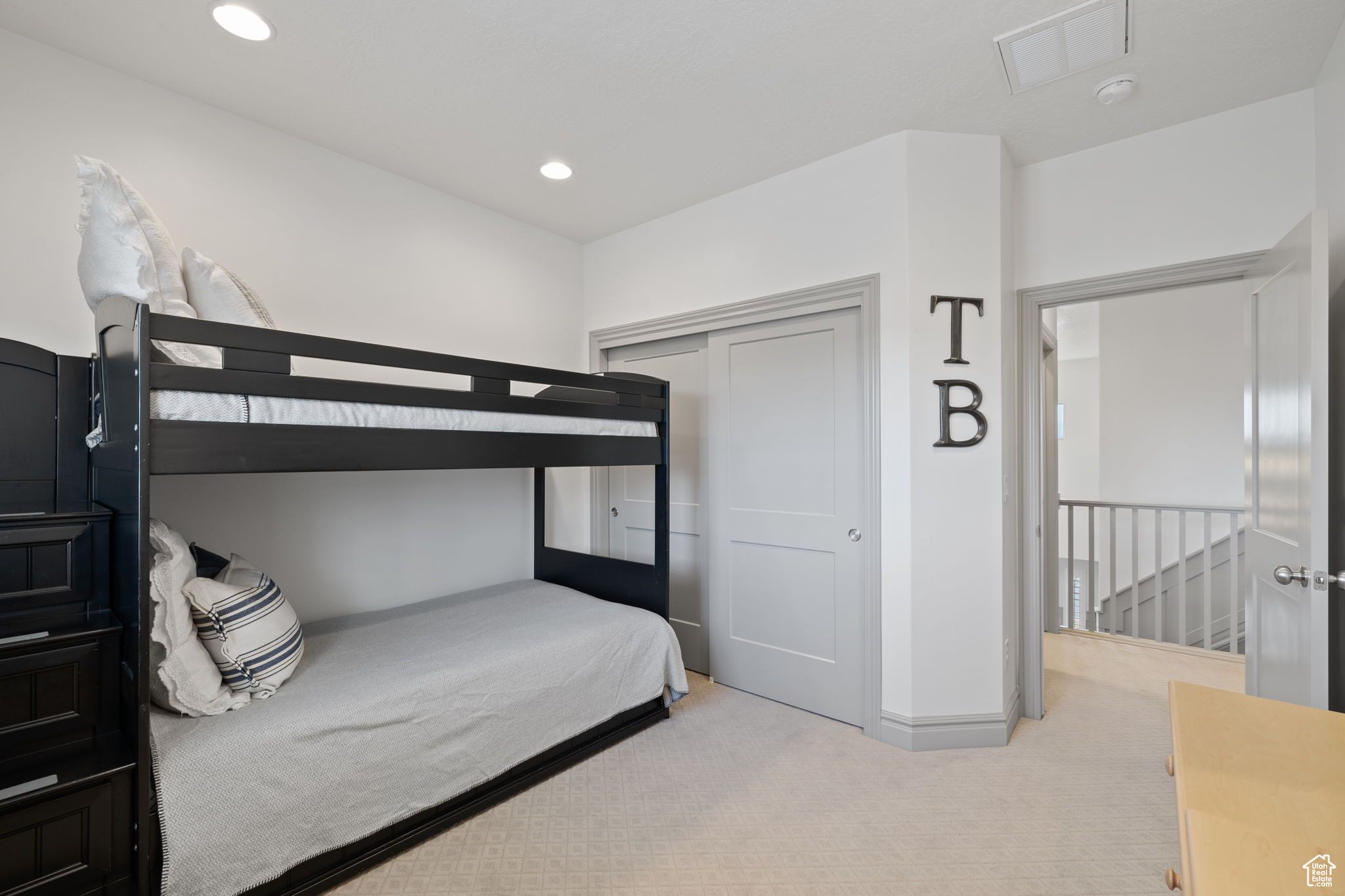 Carpeted bedroom with a closet