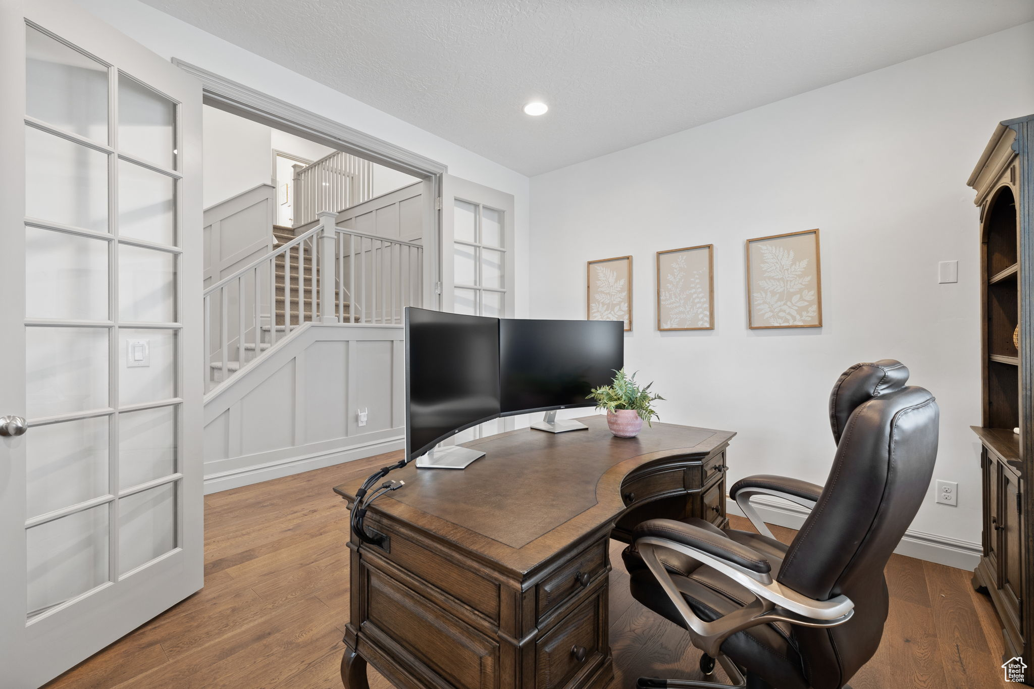 Office with french doors and light hardwood / wood-style flooring