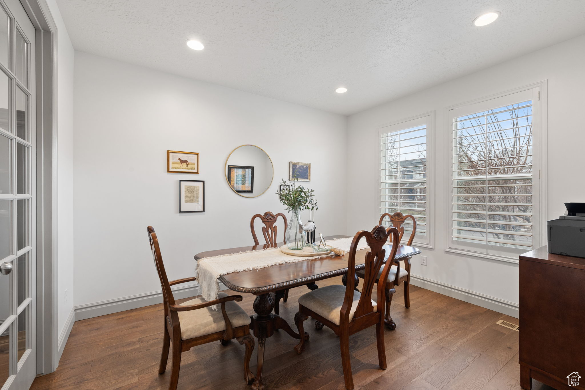 Dining area featuring a textured ceiling and dark hardwood / wood-style floors