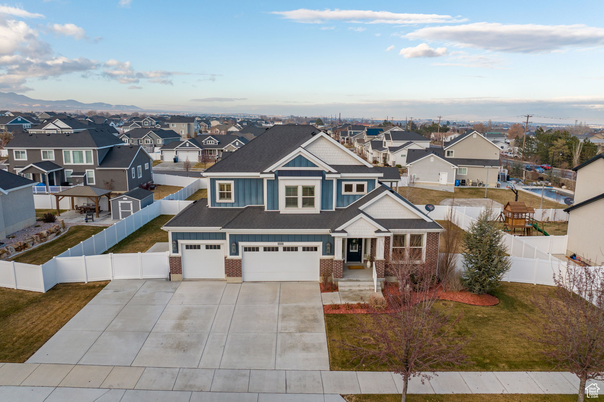 View of front of home with a mountain view and a garage