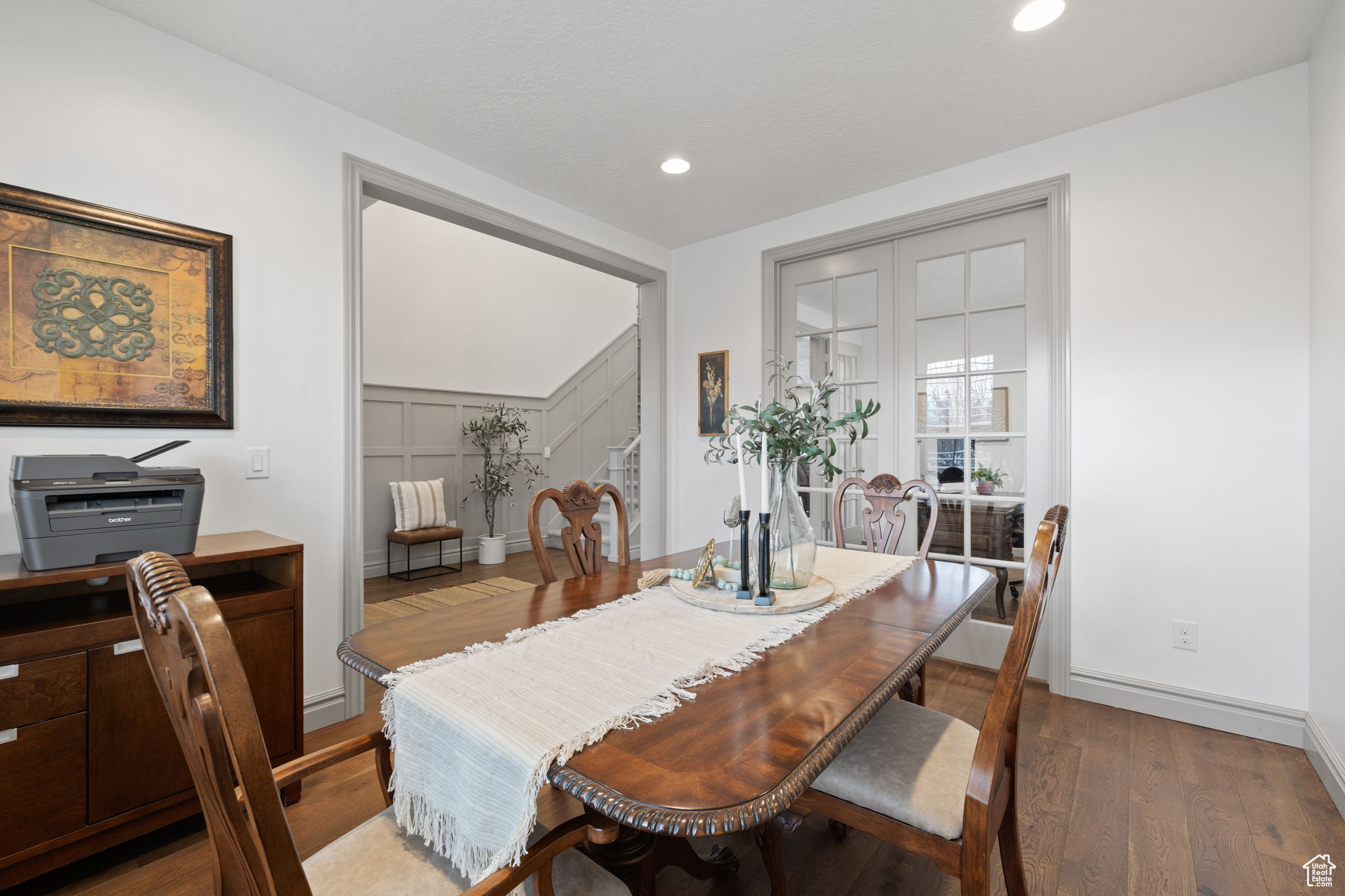 Dining room with dark hardwood / wood-style flooring