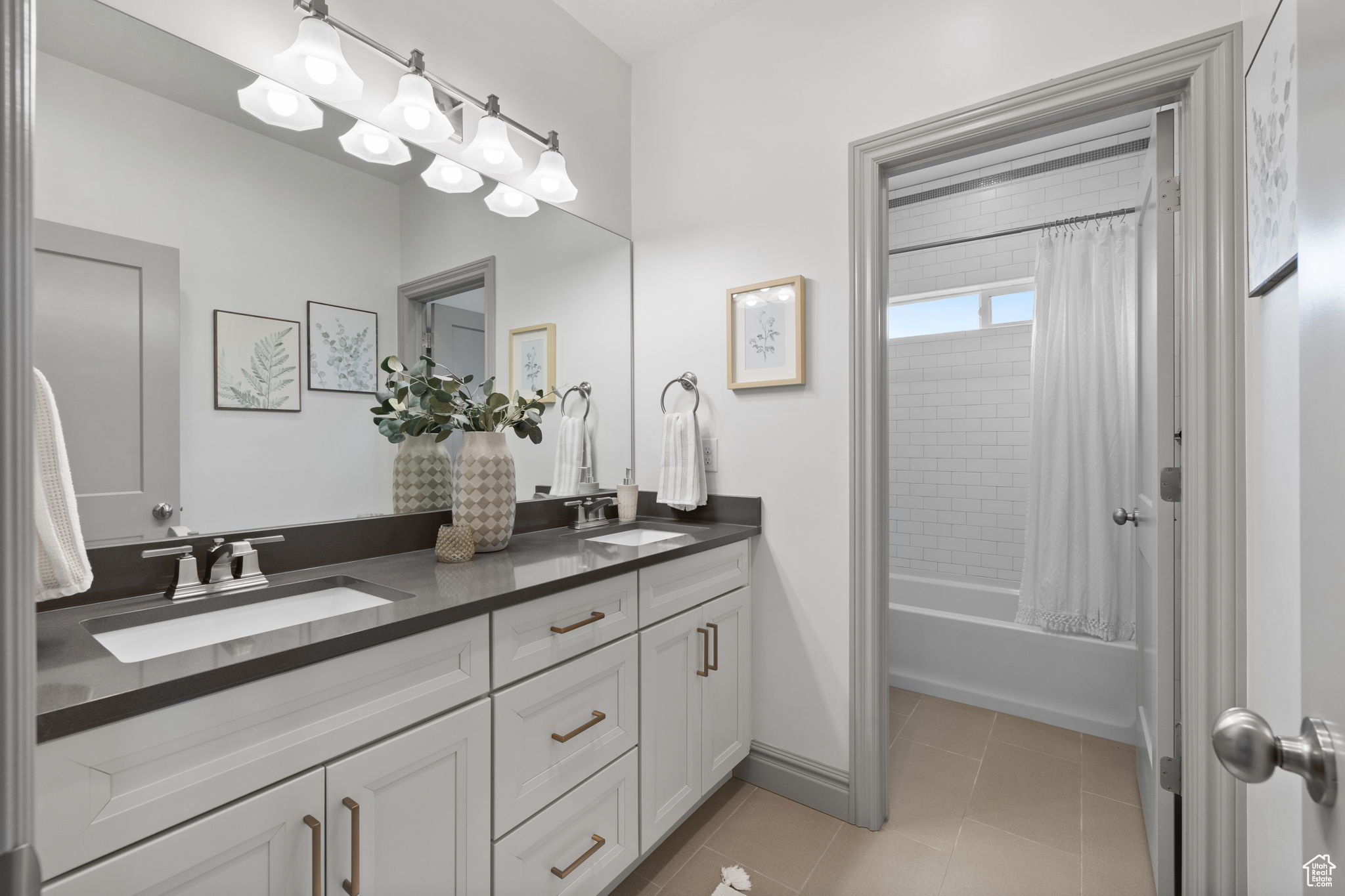 Bathroom featuring tile patterned flooring, shower / bath combo, and vanity