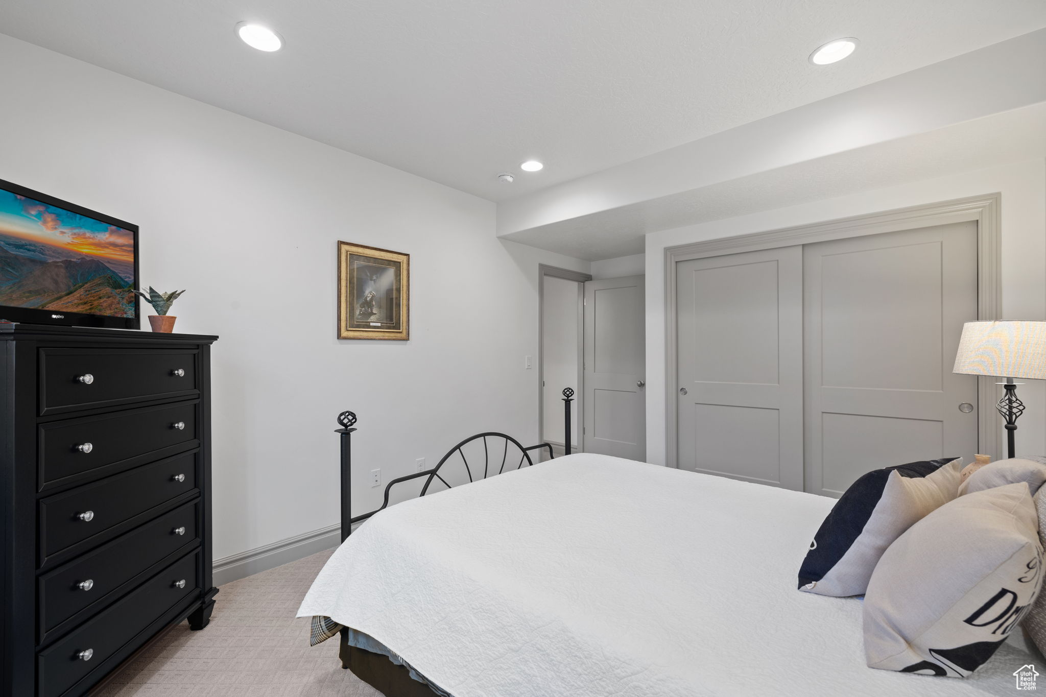 Carpeted bedroom featuring a closet