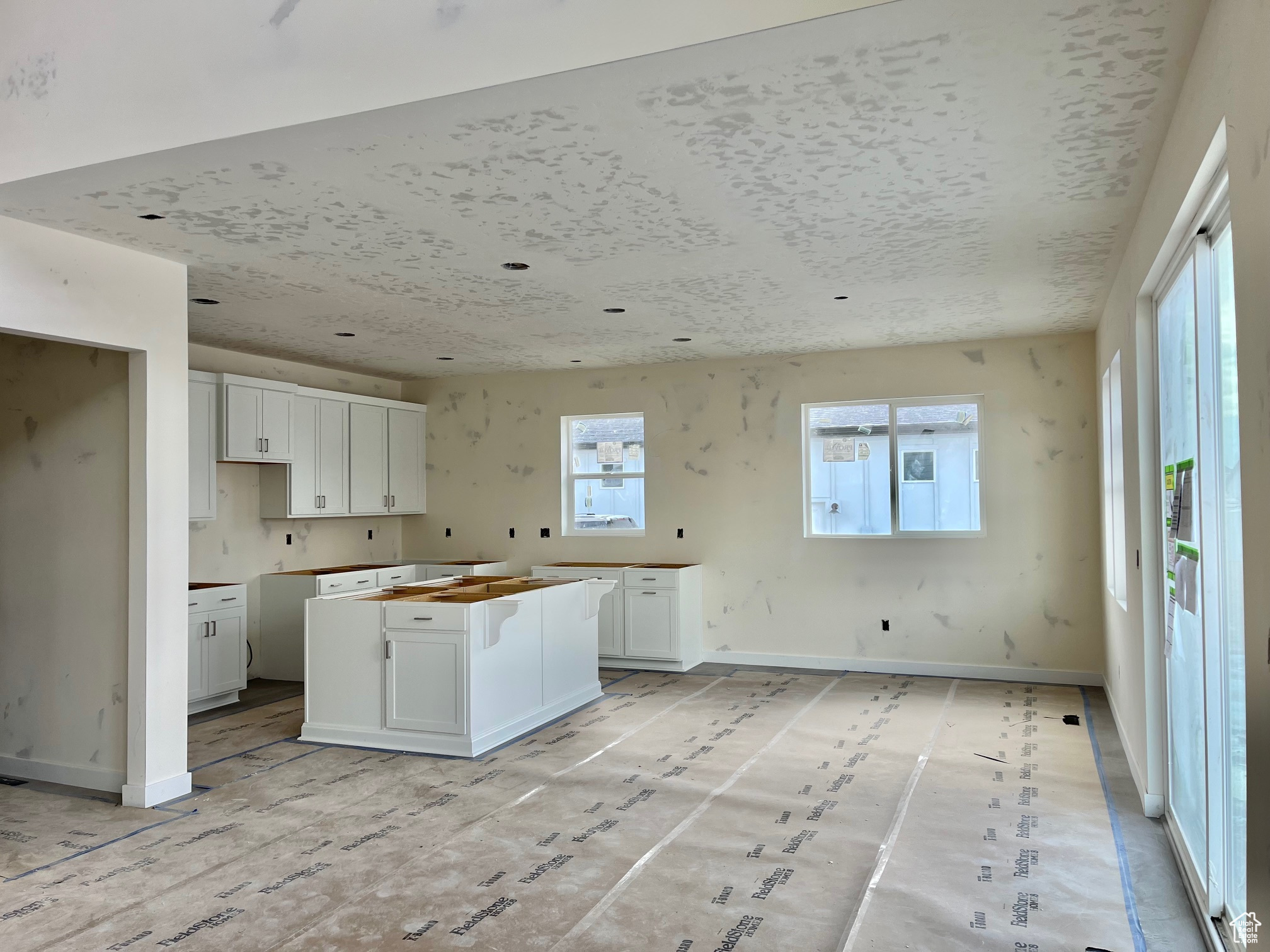 Kitchen featuring white cabinetry and a healthy amount of sunlight