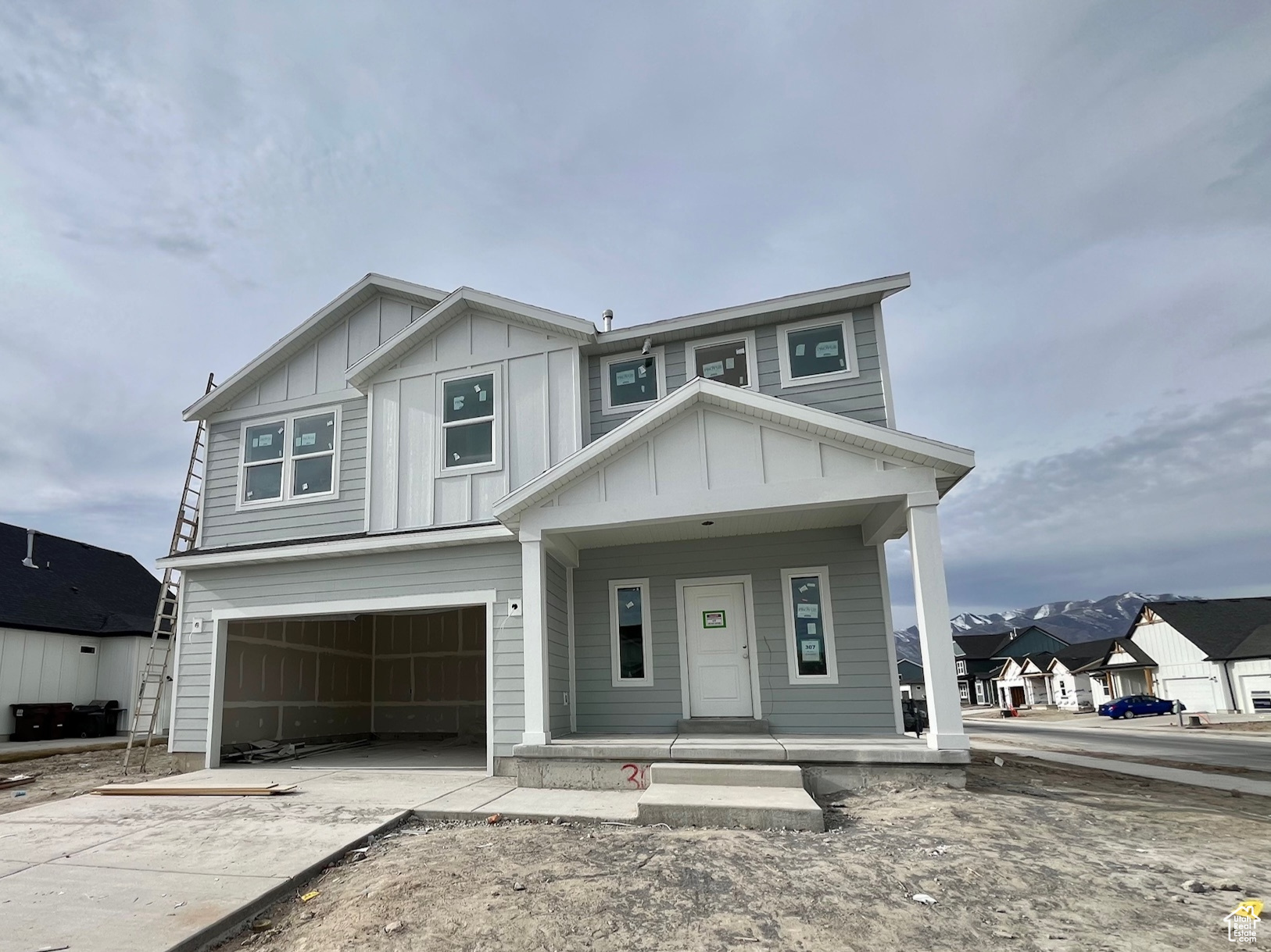 View of front of house featuring a porch and a garage