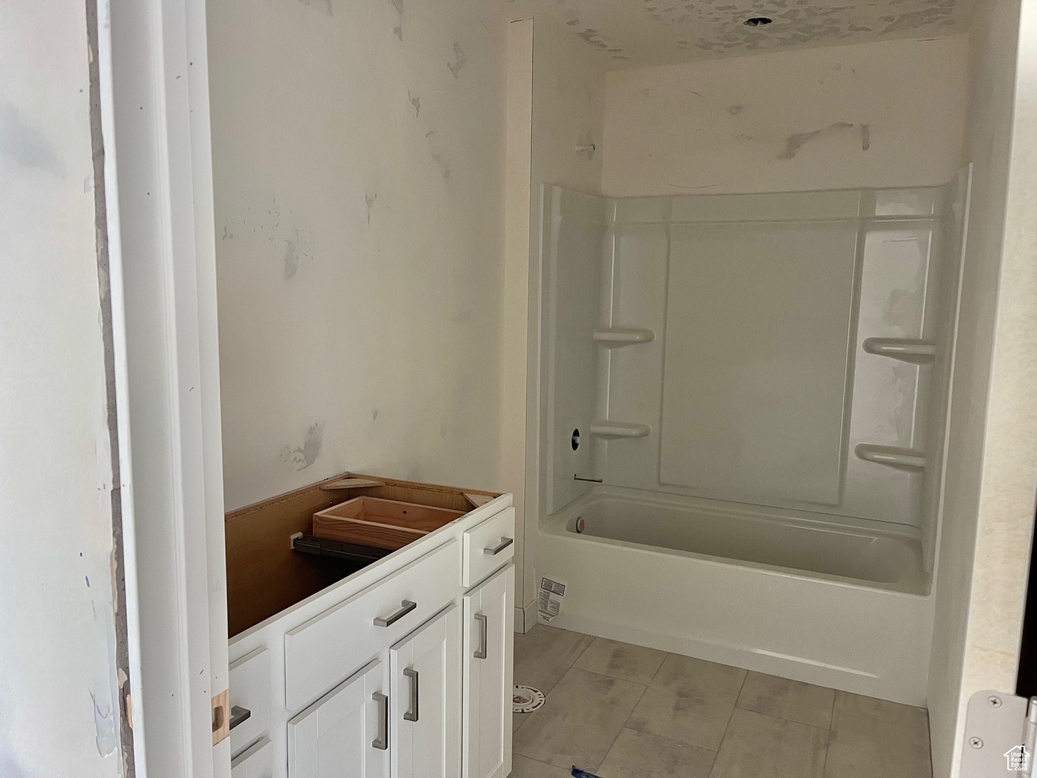 Bathroom with tile patterned floors, vanity, and bathing tub / shower combination