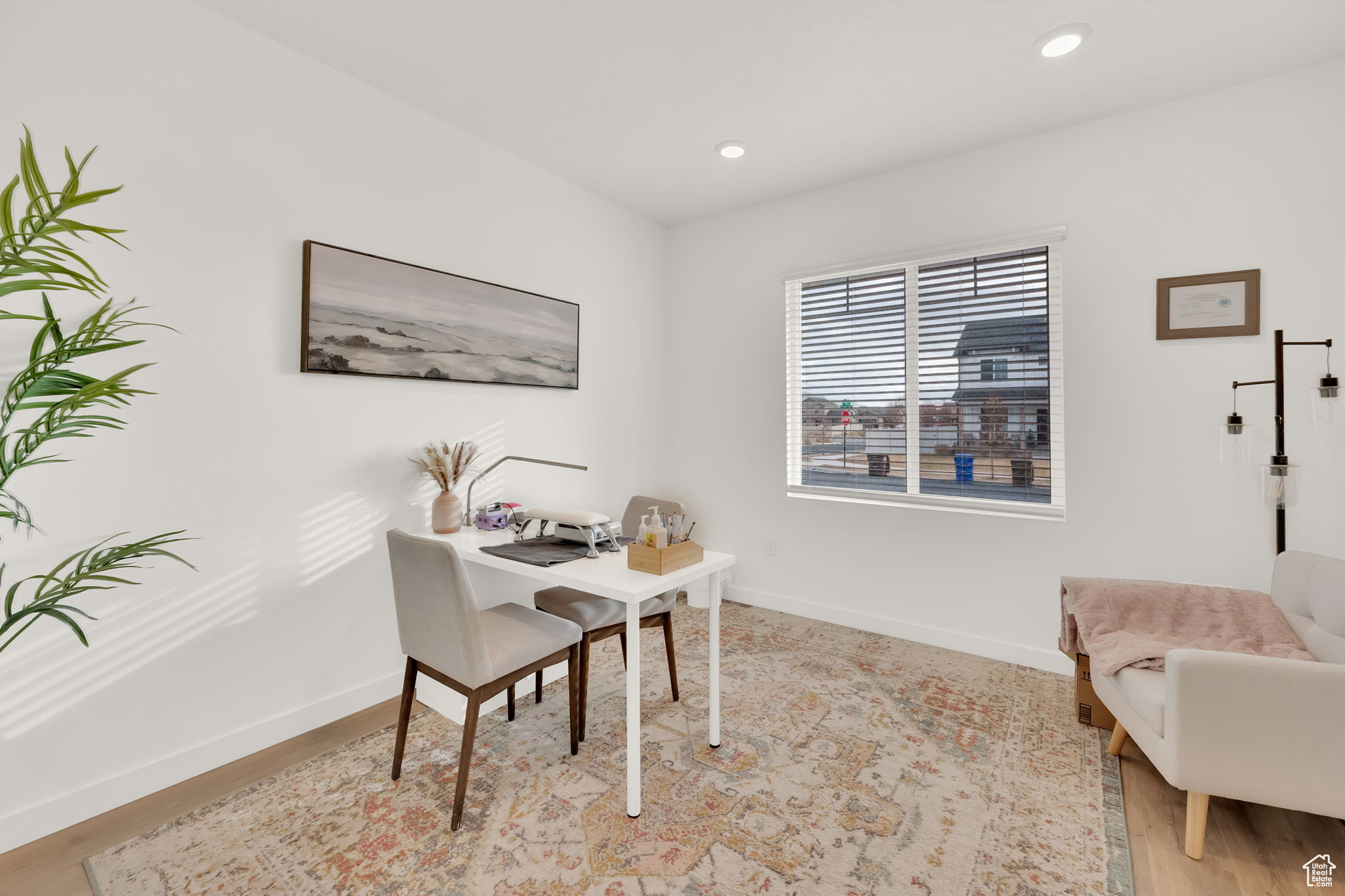 Home office with light hardwood / wood-style flooring